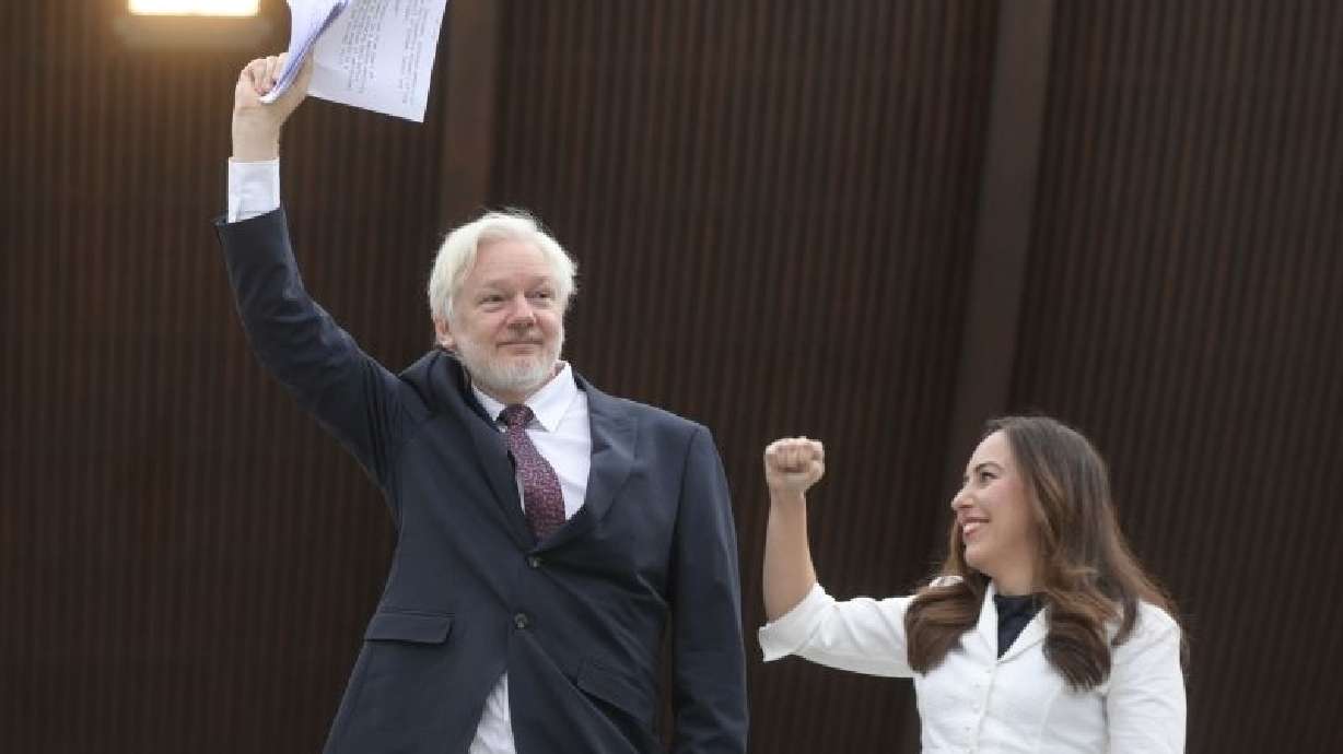 Wikileaks founder Julian Assange and his wife Stella Assange raise their arms as they arrive at the Council of Europe in Strasbourg, eastern France, Tuesday.