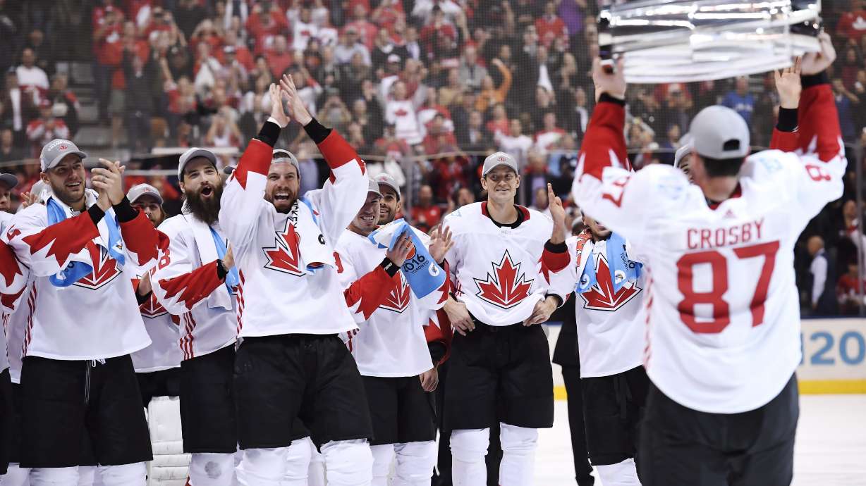 FILE - Canada's Sidney Crosby (87) hoists the trophy in front of teammates following Canada's 2-1 victory over Europe in Game 2 of the final to win the World Cup of Hockey, in Toronto, Sept. 29, 2016.