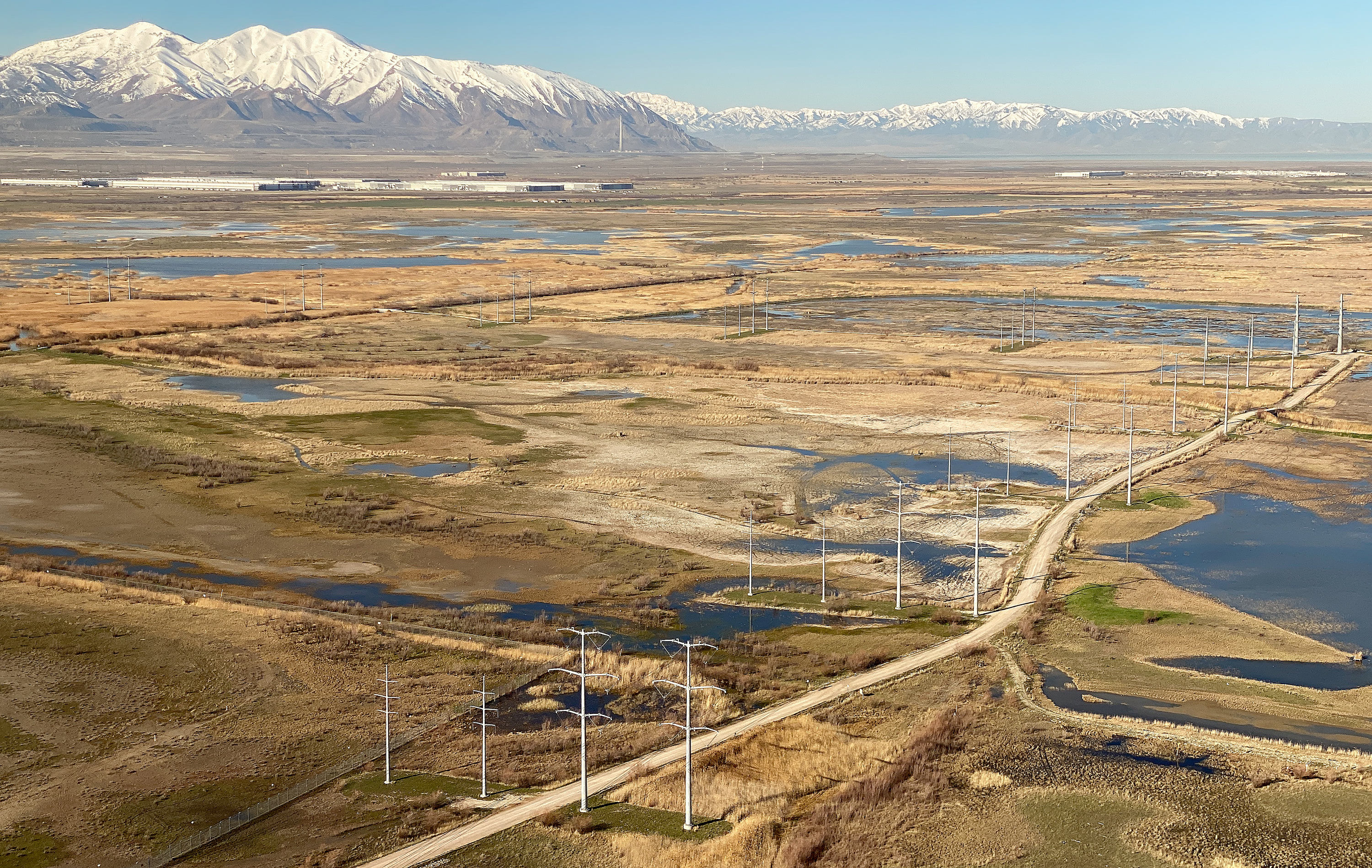 Power lines and wetlands east of the Great Salt Lake on April 3. The Kennecott Garfield Smelter Stack and Oquirrh mountains can be seen in the distance.