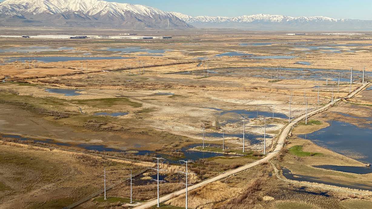 Power lines and wetlands east of the Great Salt Lake on April 3. The Kennecott Garfield Smelter Stack and Oquirrh mountains can be seen in the distance.