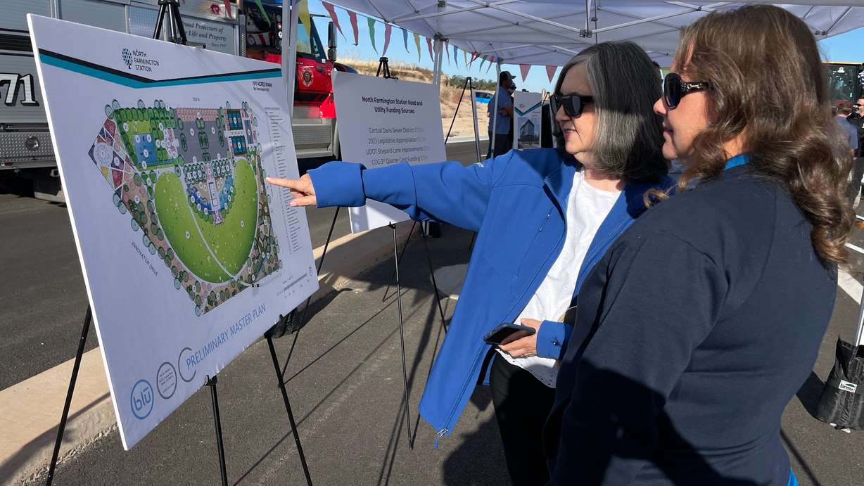 Farmington City Councilwoman Amy Shumway, right, and Eva Isaacson review plans for the North Farmington Station initiative at a ceremony on Tuesday.