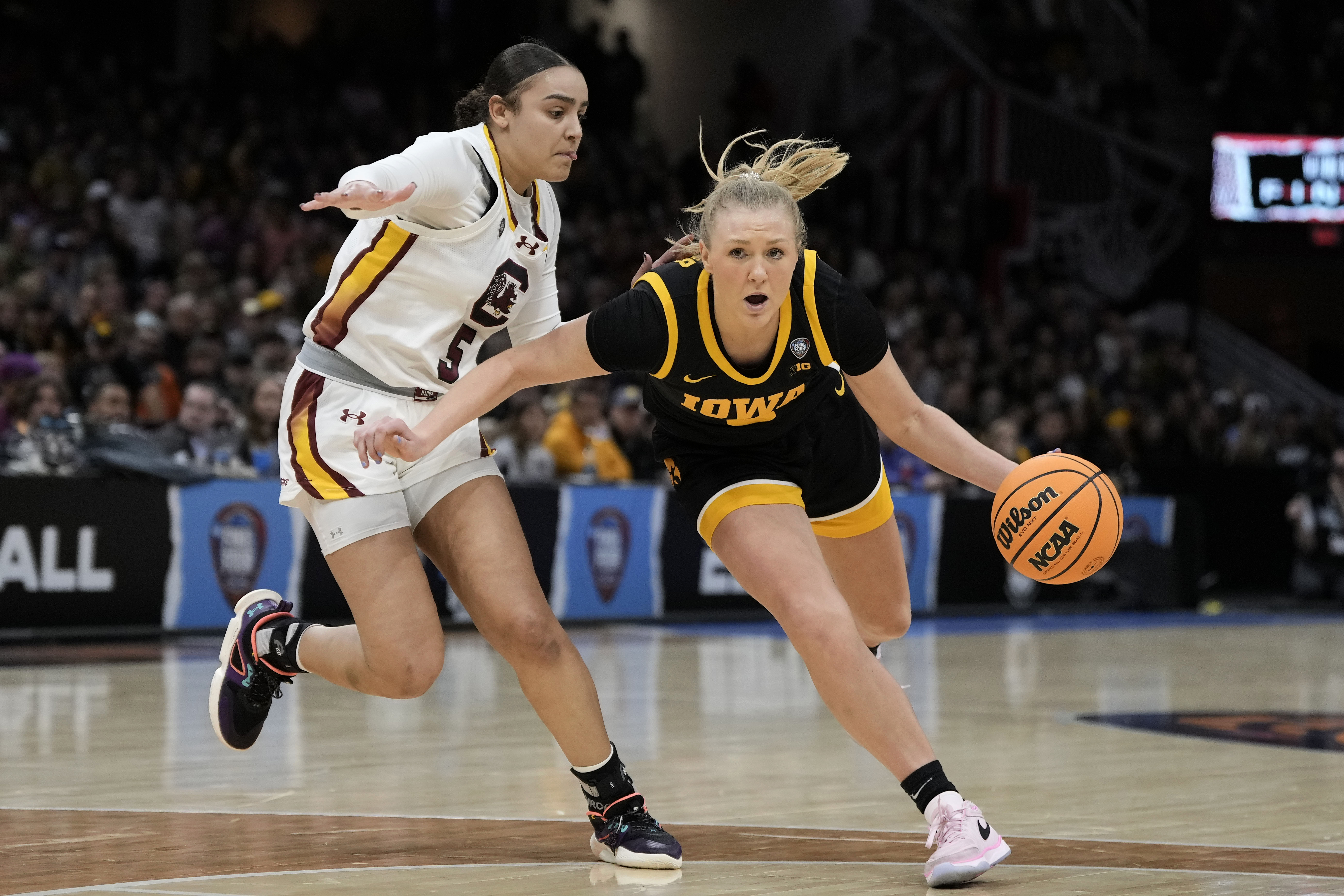 FILE - Iowa guard Sydney Affolter (3) drives past South Carolina guard Tessa Johnson (5) during the second half of the Final Four college basketball championship game in the women's NCAA Tournament, April 7, 2024, in Cleveland. 