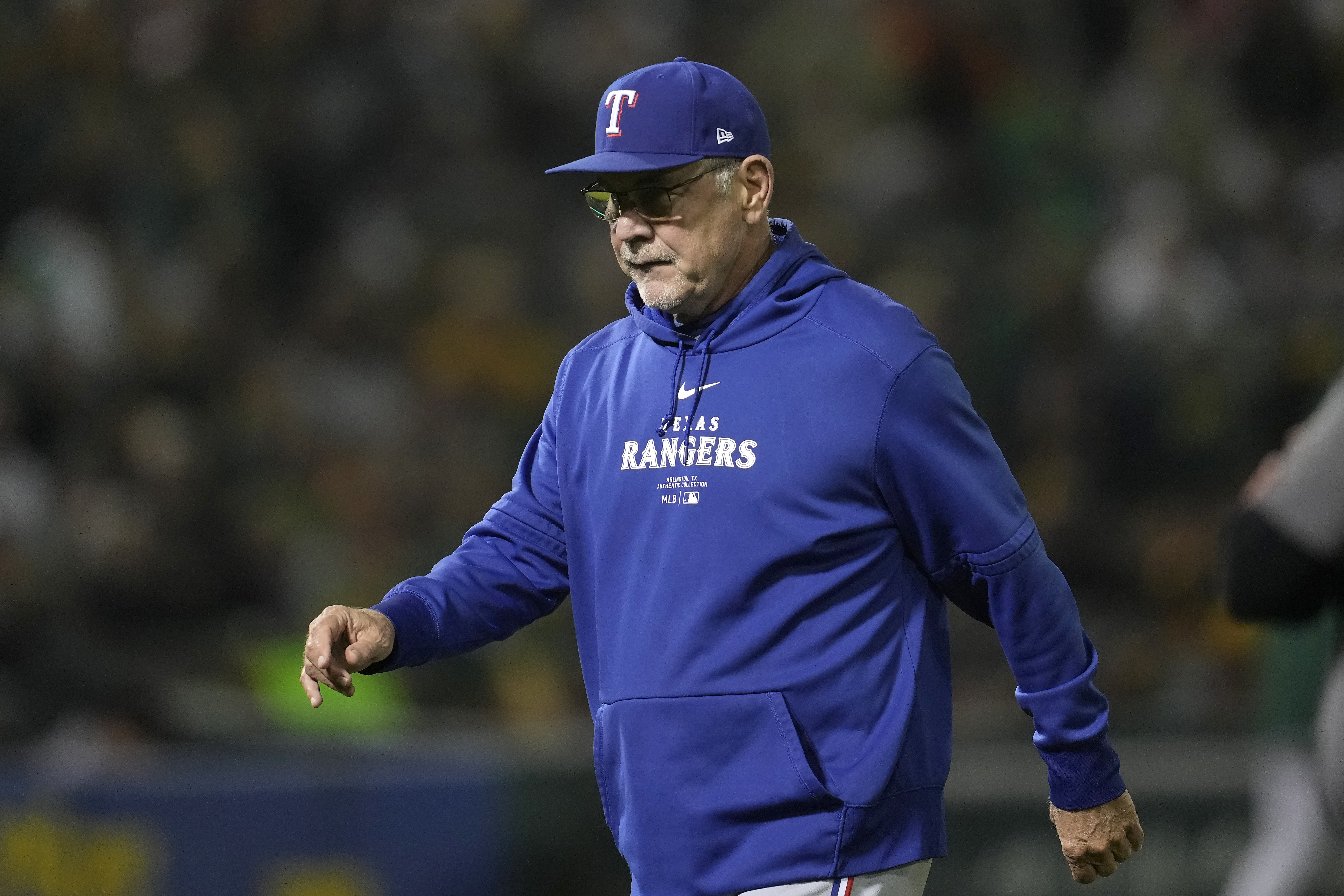 Texas Rangers manager Bruce Bochy walks to the dugout after making a pitching change during the fourth inning of a baseball game against the Oakland Athletics in Oakland, Calif., Wednesday, Sept. 25, 2024. 