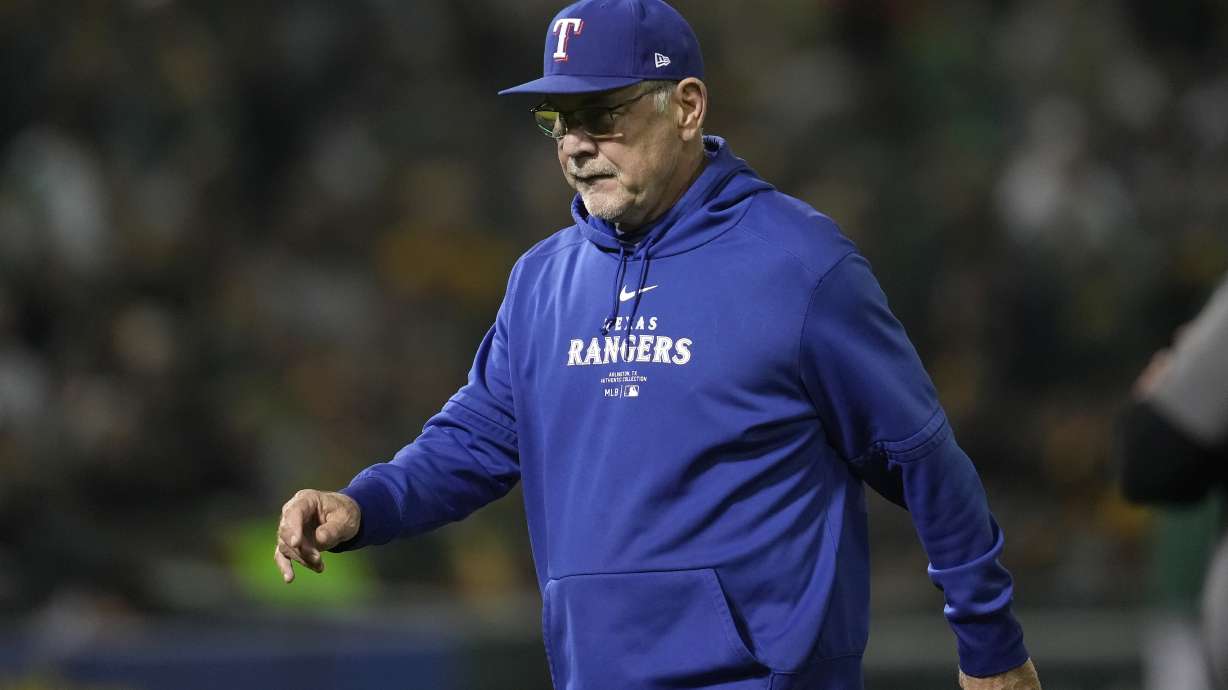 Texas Rangers manager Bruce Bochy walks to the dugout after making a pitching change during the fourth inning of a baseball game against the Oakland Athletics in Oakland, Calif., Wednesday, Sept. 25, 2024.