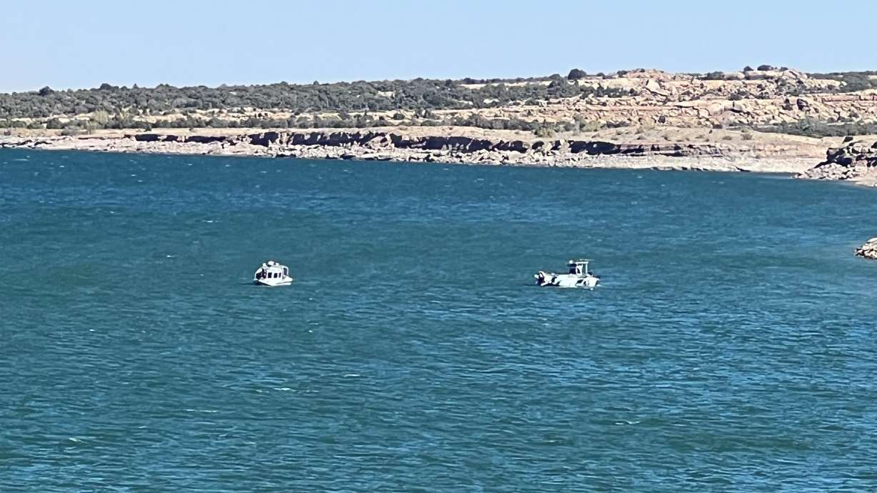 Crews recover a vehicle from Starvation Reservoir on Monday.