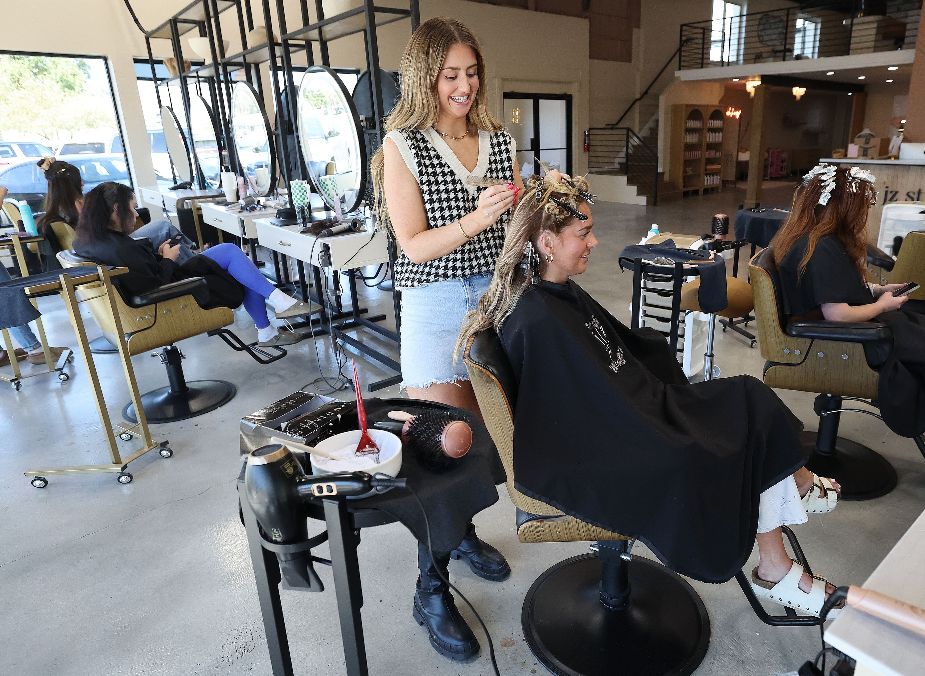 Hairstylist Megan Robertson works with Bri Kelsch’s hair at JZ Styles in Pleasant Grove on Tuesday. As more of Generation Z enters the workforce, their career choices vary slightly from those of previous generations.