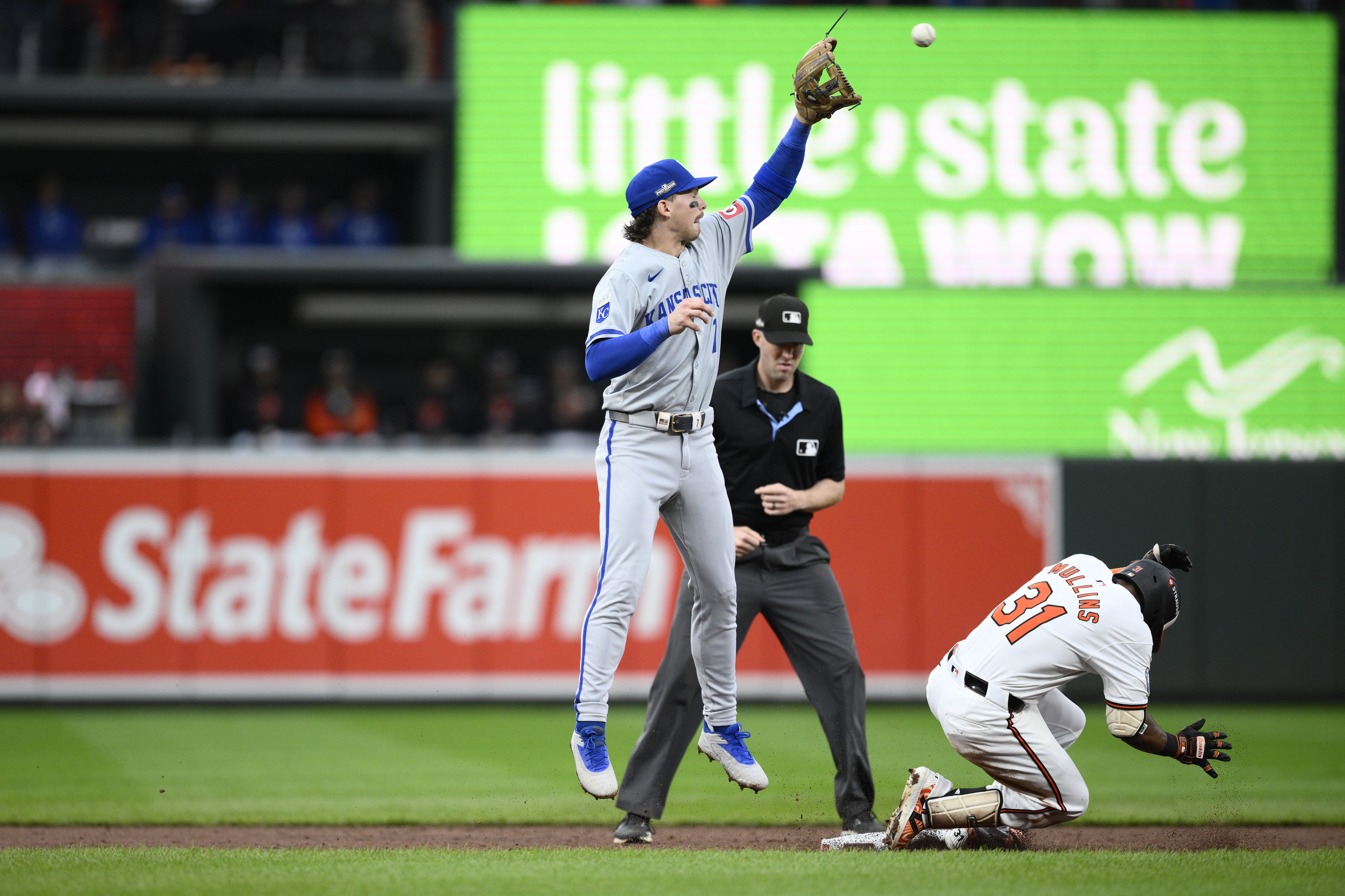 Baltimore Orioles' Cedric Mullins (31) reaches second base with a double against Kansas City Royals shortstop Bobby Witt Jr., left, in the third inning during Game 1 of an AL Wild Card Series baseball game, Tuesday, Oct. 1, 2024, in Baltimore.