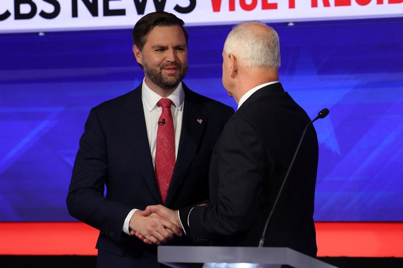 Democratic vice presidential nominee Minnesota Gov. Tim Walz and Republican vice presidential nominee U.S. Senator JD Vance, R-Ohio, shake hands as they attend a debate hosted by CBS in New York, Tuesday.