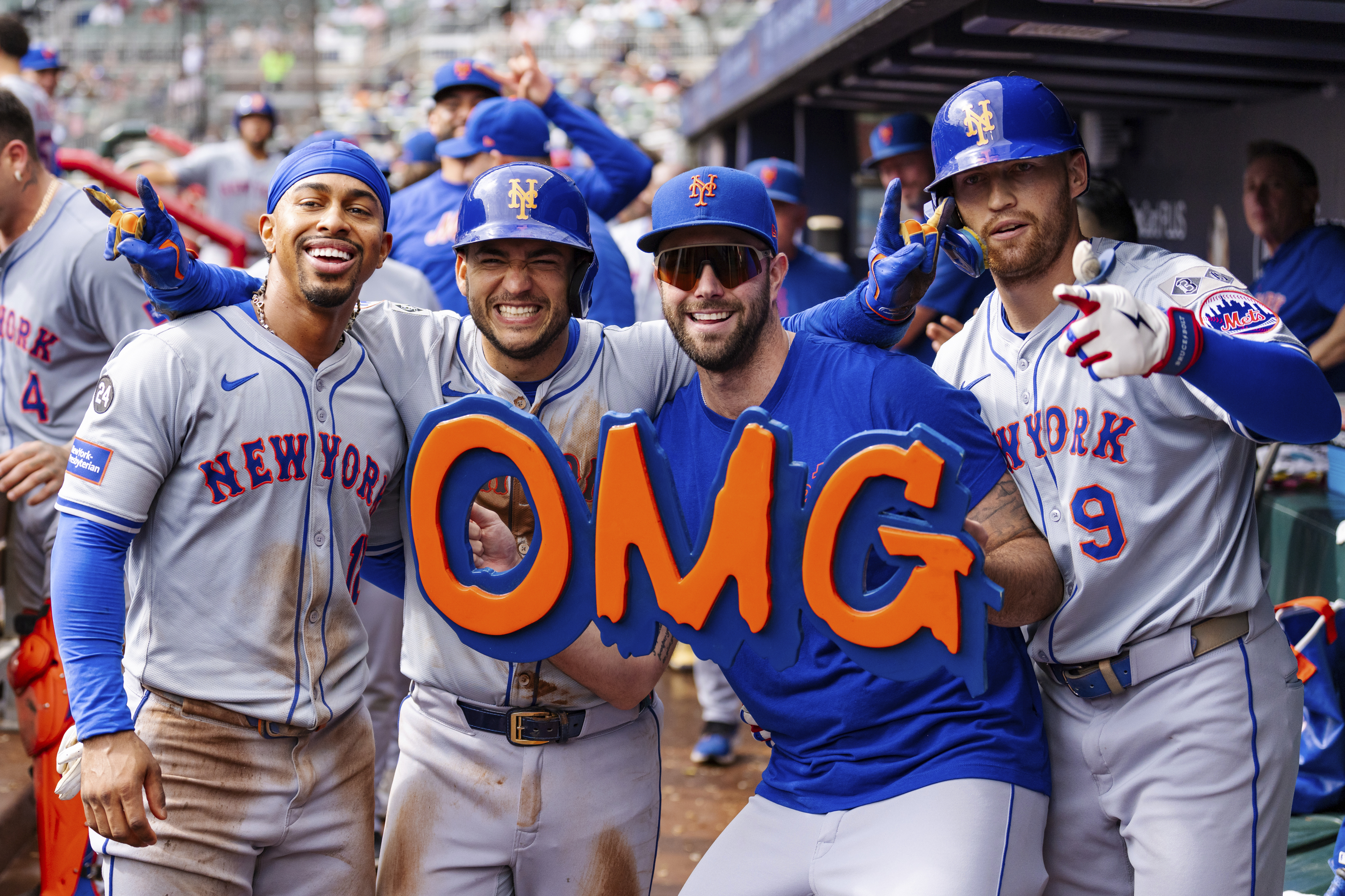 New York Mets' Francisco Lindor, left, Jose Iglesias, left center, David Peterson, right center, and Brandon Nimmo, right, celebrate in the dugout after taking the lead in the eighth inning of a baseball game against the Atlanta Braves, Monday, Sept. 30, 2024, in Atlanta. 