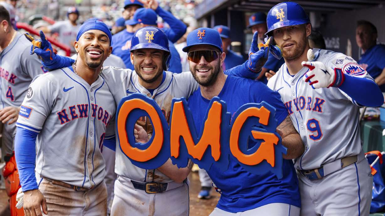 New York Mets' Francisco Lindor, left, Jose Iglesias, left center, David Peterson, right center, and Brandon Nimmo, right, celebrate in the dugout after taking the lead in the eighth inning of a baseball game against the Atlanta Braves, Monday, Sept. 30, 2024, in Atlanta.