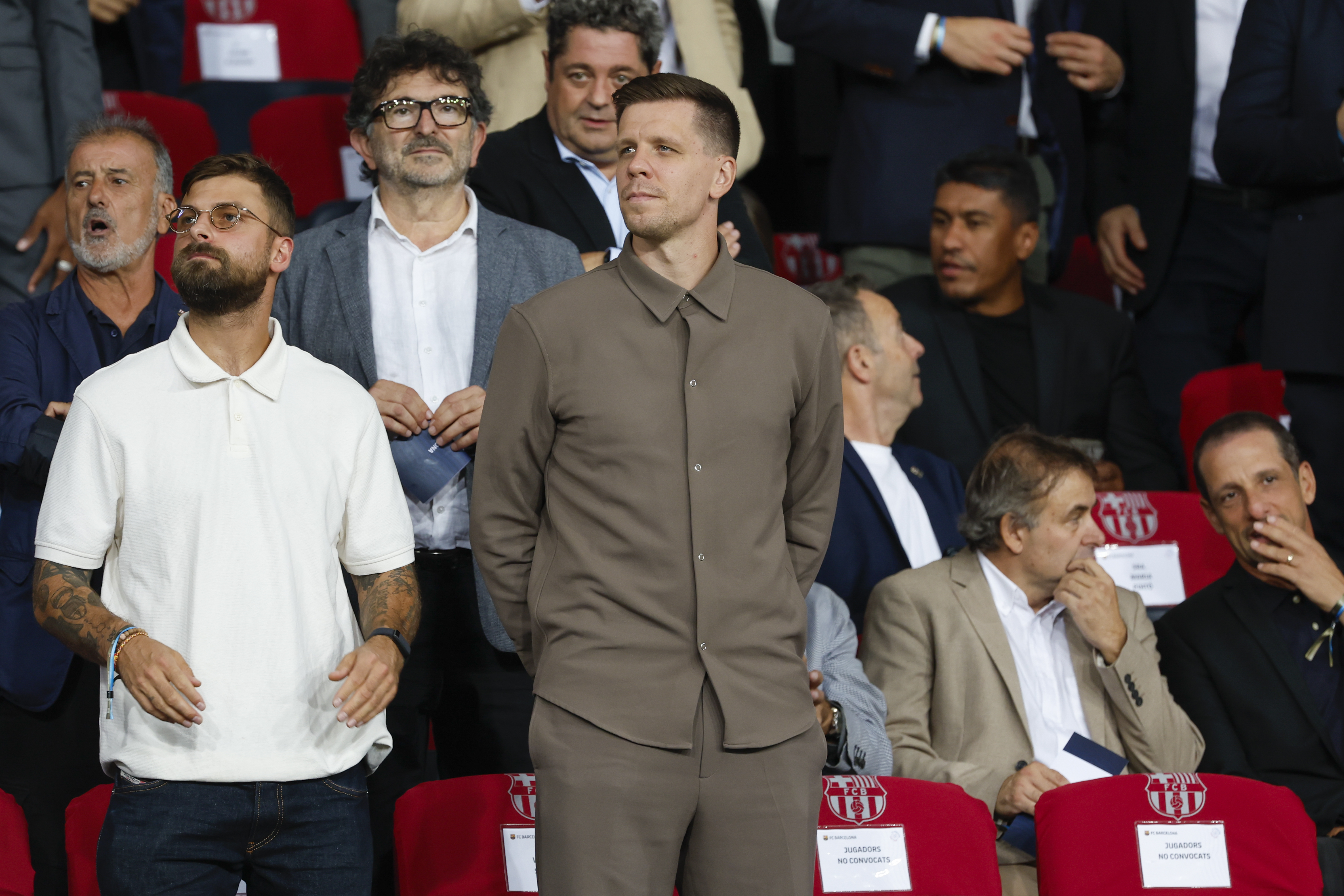 Wojciech Szczesny, centre, a new goalkeeper for Barcelona is on stands during the Champions League soccer match between Barcelona and Young Boys at the Lluis Companys Olympic Stadium in Barcelona, Spain, Tuesday, Oct. 1, 2024. 