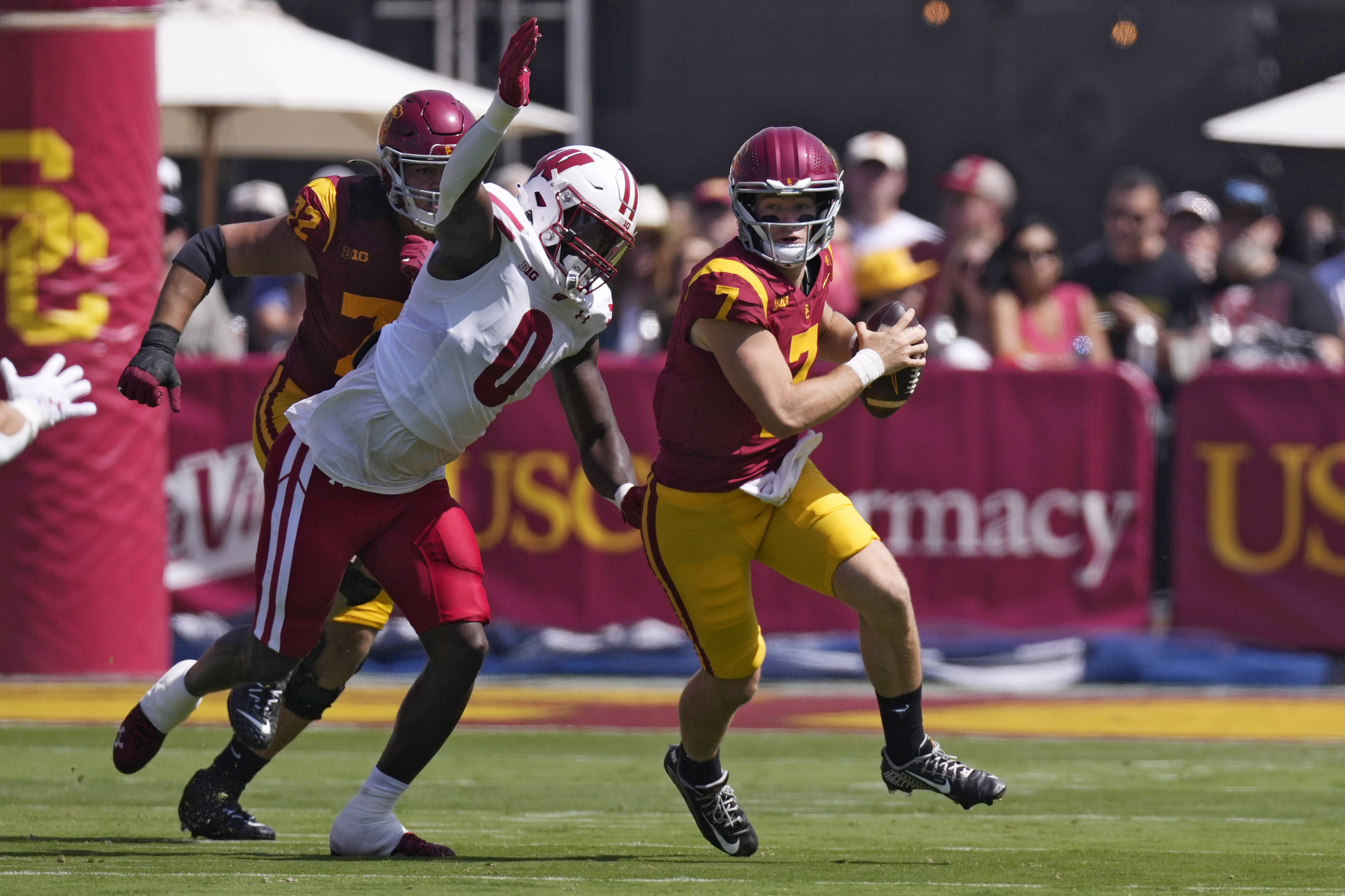 Southern California quarterback Miller Moss, right, is tackled by Wisconsin linebacker John Pius during the first half of an NCAA college football game, Saturday, Sept. 28, 2024, in Los Angeles. 