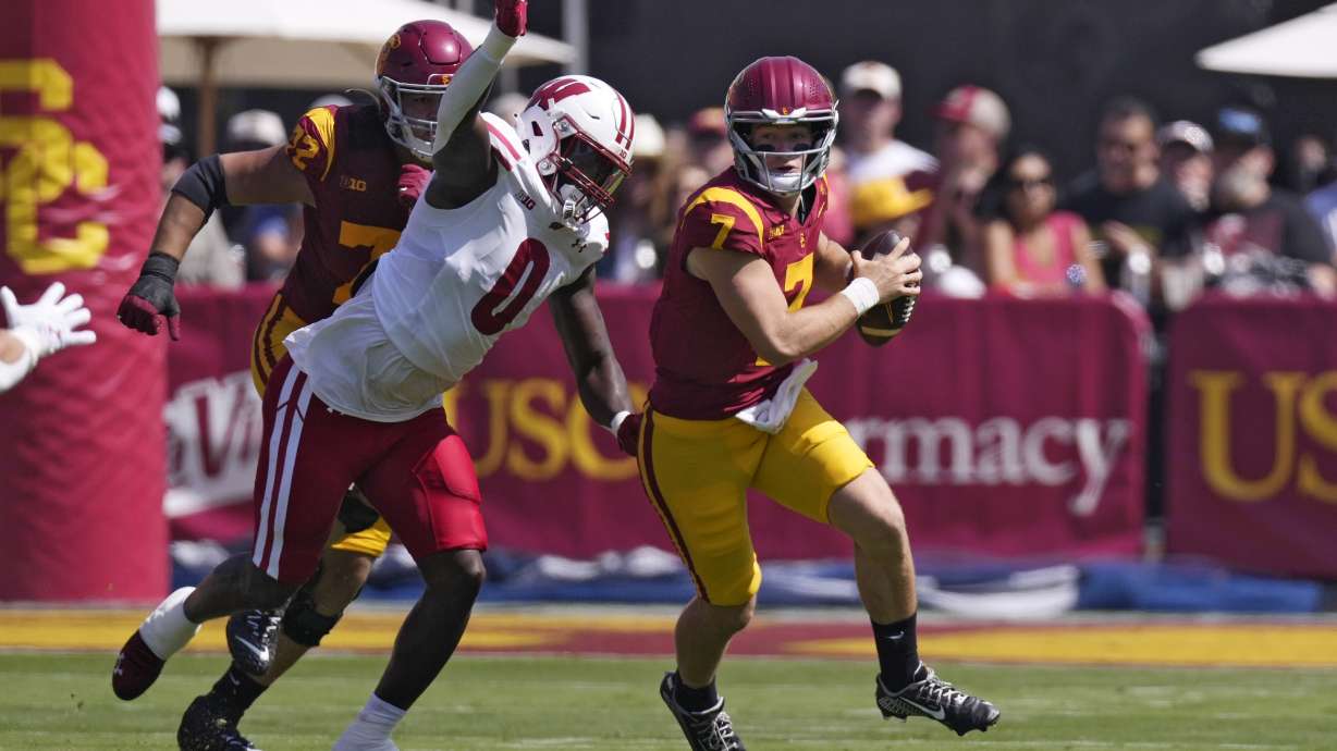 Southern California quarterback Miller Moss, right, is tackled by Wisconsin linebacker John Pius during the first half of an NCAA college football game, Saturday, Sept. 28, 2024, in Los Angeles.