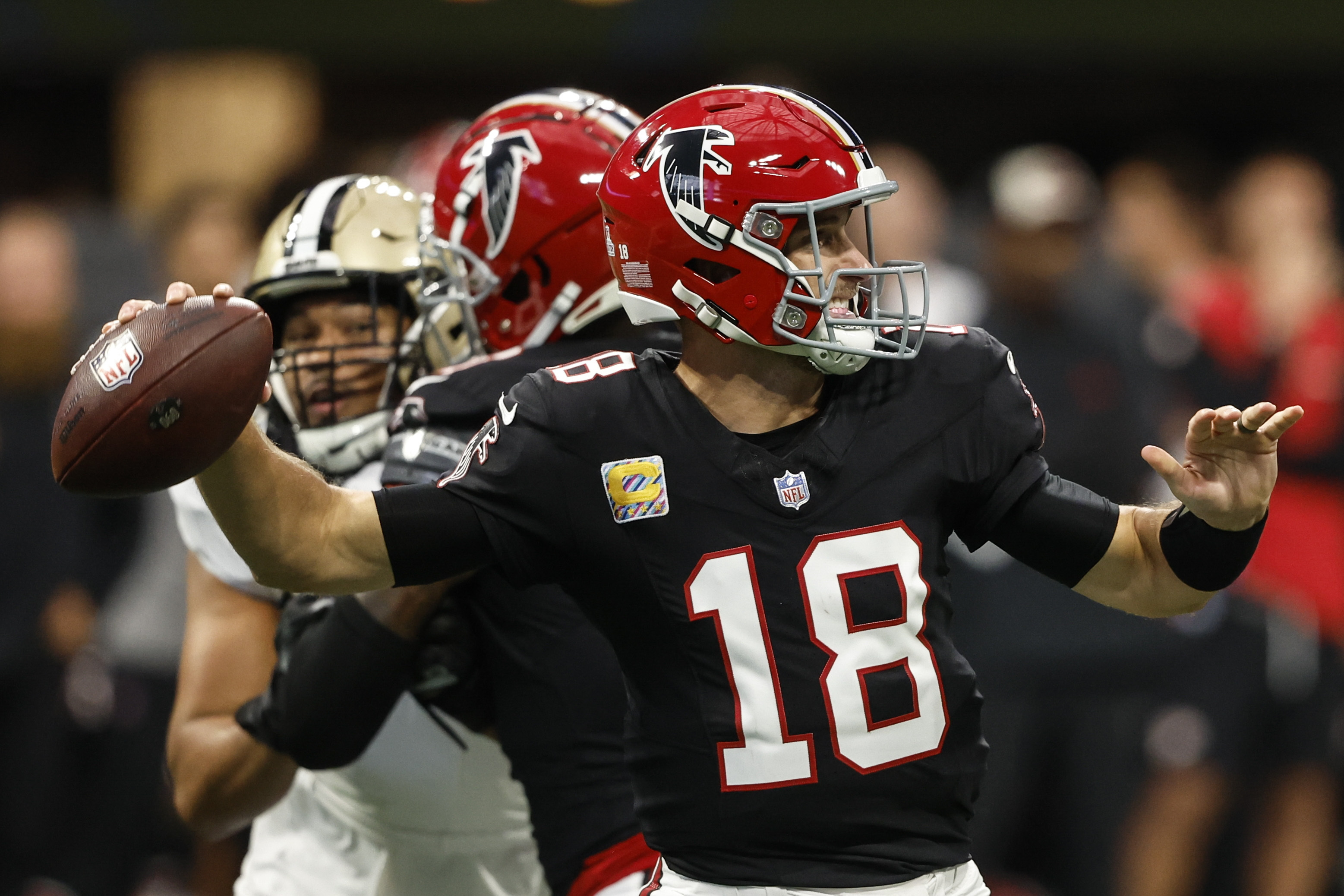 Atlanta Falcons quarterback Kirk Cousins (18) works against the New Orleans Saints during the first half of an NFL football game, Sunday, Sept. 29, 2024, in Atlanta. 