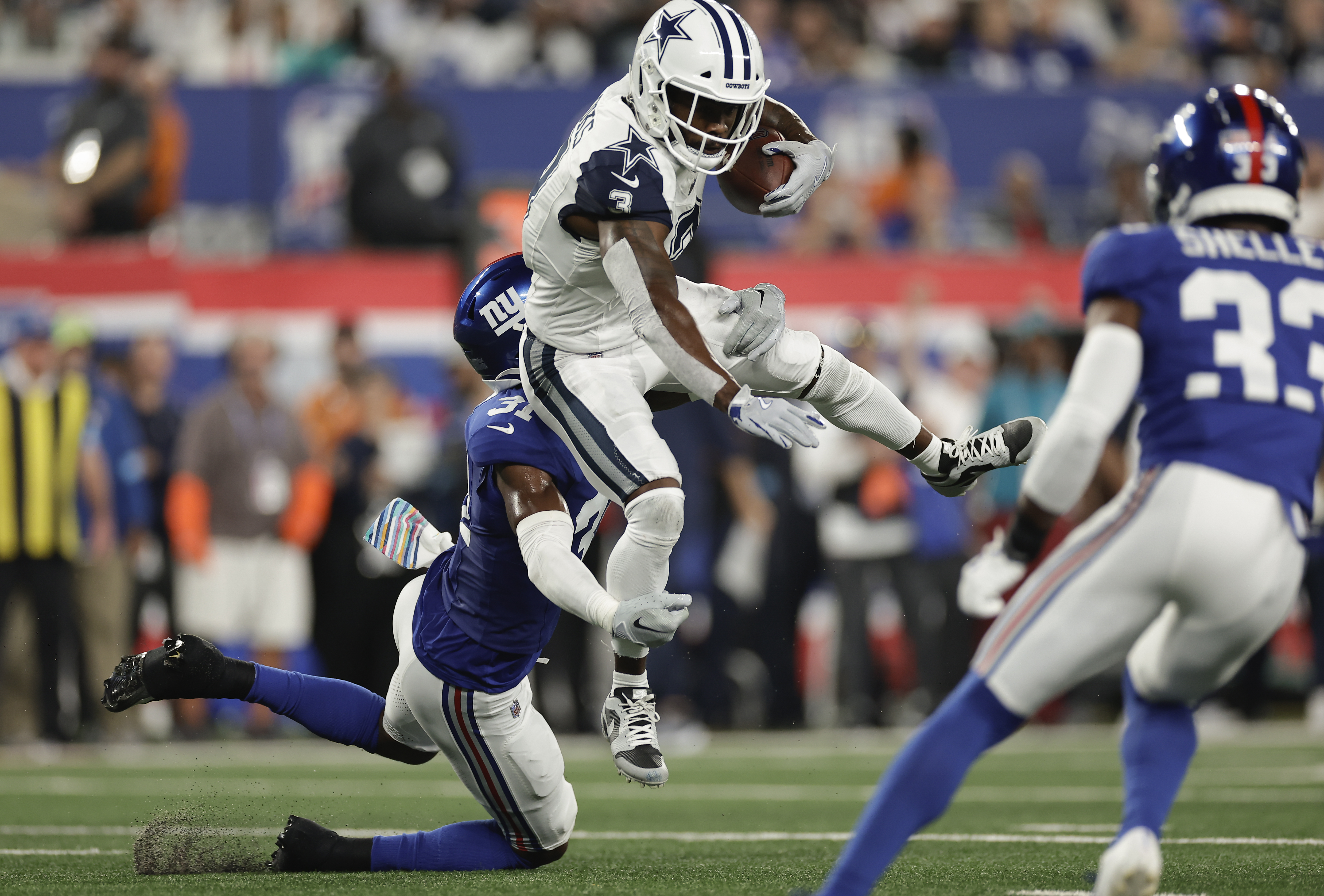 Dallas Cowboys wide receiver Brandin Cooks (3) tries to avoid a tackle from New York Giants safety Tyler Nubin (31) during the first quarter of an NFL football game, Thursday, Sept. 26, 2024, in East Rutherford, N.J. 