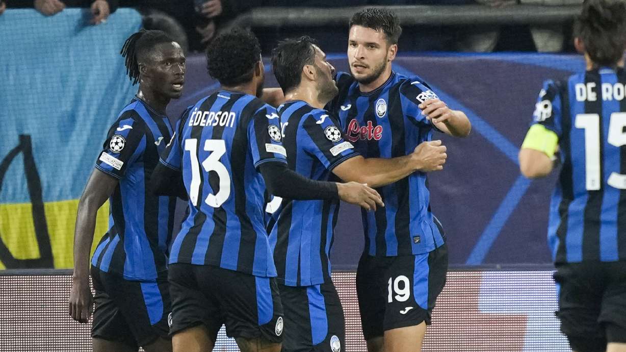Atalanta's Berat Djimsiti celebrates with his teammates after scoring the opening goal during the Champions League opening phase soccer match between Shakhtar Donetsk and Atalanta at the Arena AufSchalke in Gelsenkirchen, Germany, Wednesday Oct. 2, 2024.