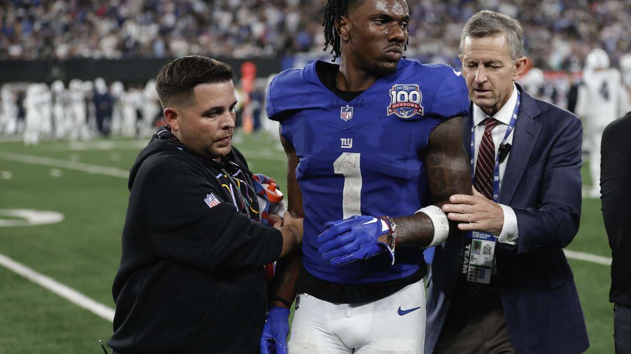 New York Giants wide receiver Malik Nabers (1) is helped off the field after an injury during the fourth quarter of an NFL football game against the Dallas Cowboys, Thursday, Sept. 26, 2024, in East Rutherford, N.J.