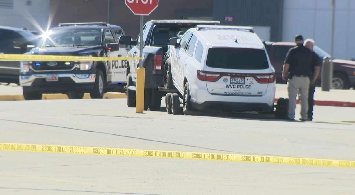 A police vehicle is towed away from the scene of a police pursuit and head-on crash that killed a woman near Valley Fair Mall in West Valley City on Wednesday. The driver who was arrested also rammed two police vehicles.
