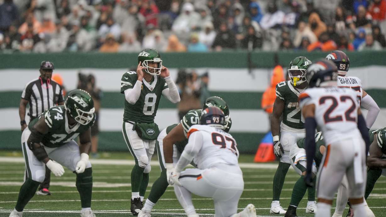 New York Jets quarterback Aaron Rodgers (8) calls an audible at the line of scrimmage against the Denver Broncos during the second quarter of an NFL football game, Sunday, Sept. 29, 2024, in East Rutherford, N.J.