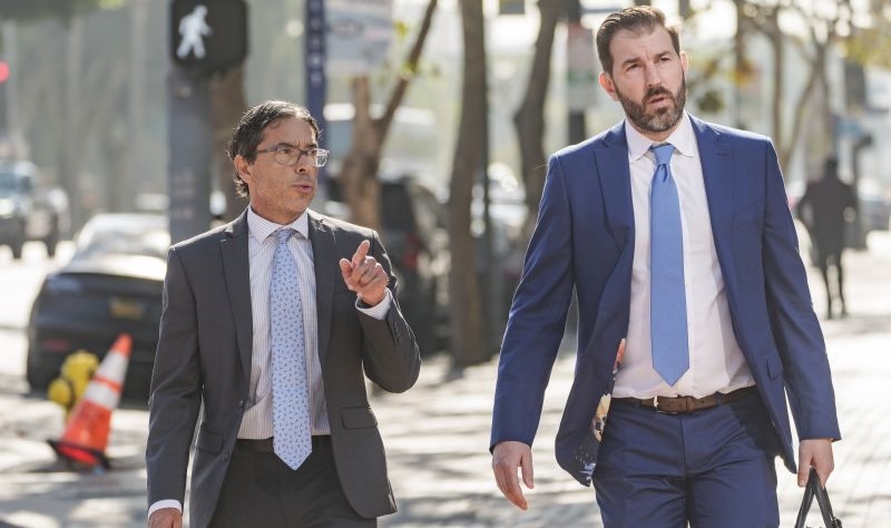 Dr. Mark Chavez, a physician from San Diego, left, who is charged in connection with actor Matthew Perry's death from an accidental ketamine overdose, and his criminal defense attorney Matthew Binninger arrive at the United States Courthouse in Los Angeles, on Wednesday. Chavez pleaded guilty.