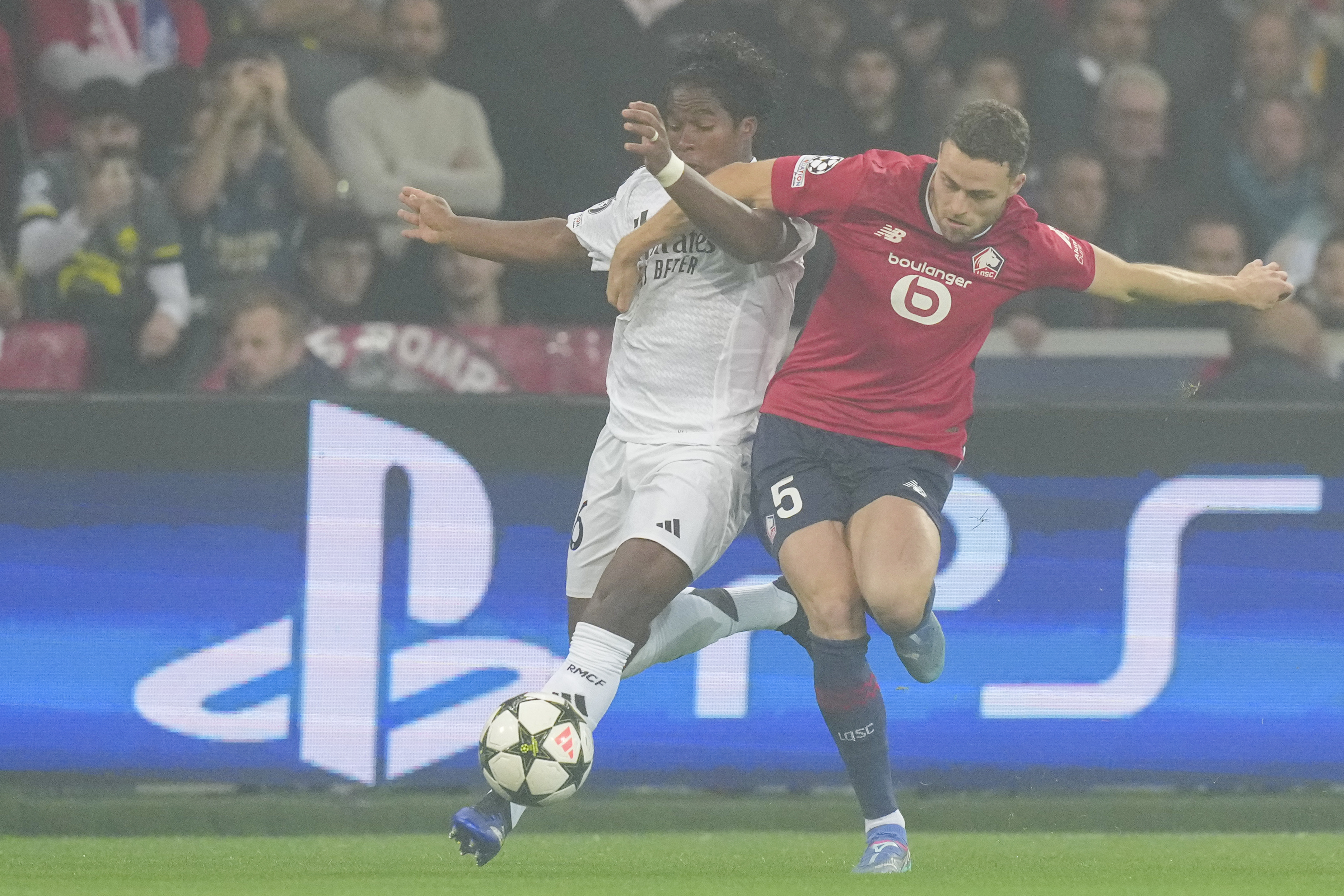 Lille's Gabriel Gudmundsson, right, and Real Madrid's Endrick compete for the ball during the Champions League opening phase soccer match between Lille and Real Madrid at the Stade Pierre Mauroy in Villeneuve-d'Ascq, outside Lille, France, Wednesday, Oct. 2, 2024. 