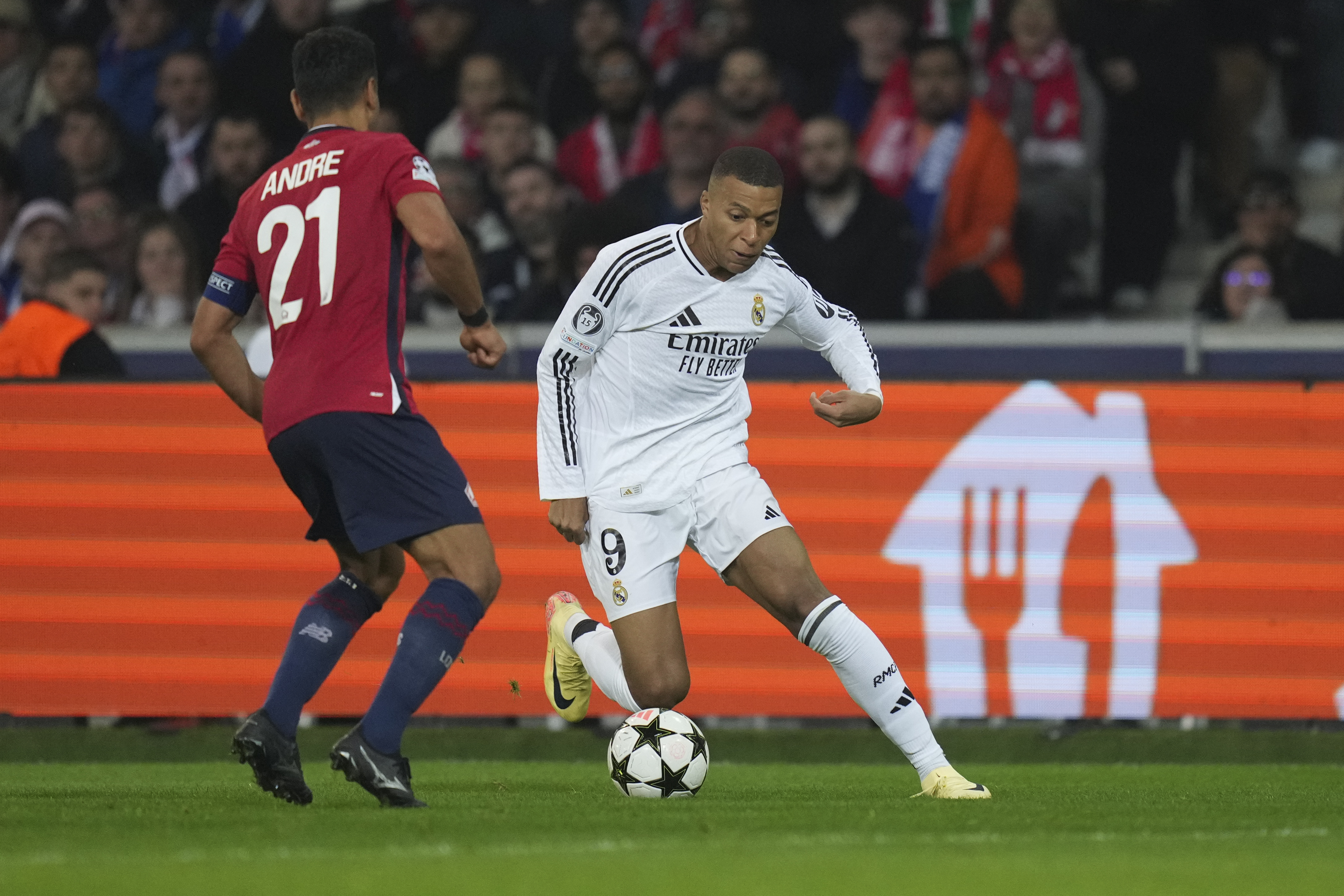 Real Madrid's Kylian Mbappe, right, dribbles the ball past Lille's Benjamin Andre during the Champions League opening phase soccer match between Lille and Real Madrid at the Stade Pierre Mauroy in Villeneuve-d'Ascq, outside Lille, France, Wednesday, Oct. 2, 2024. 