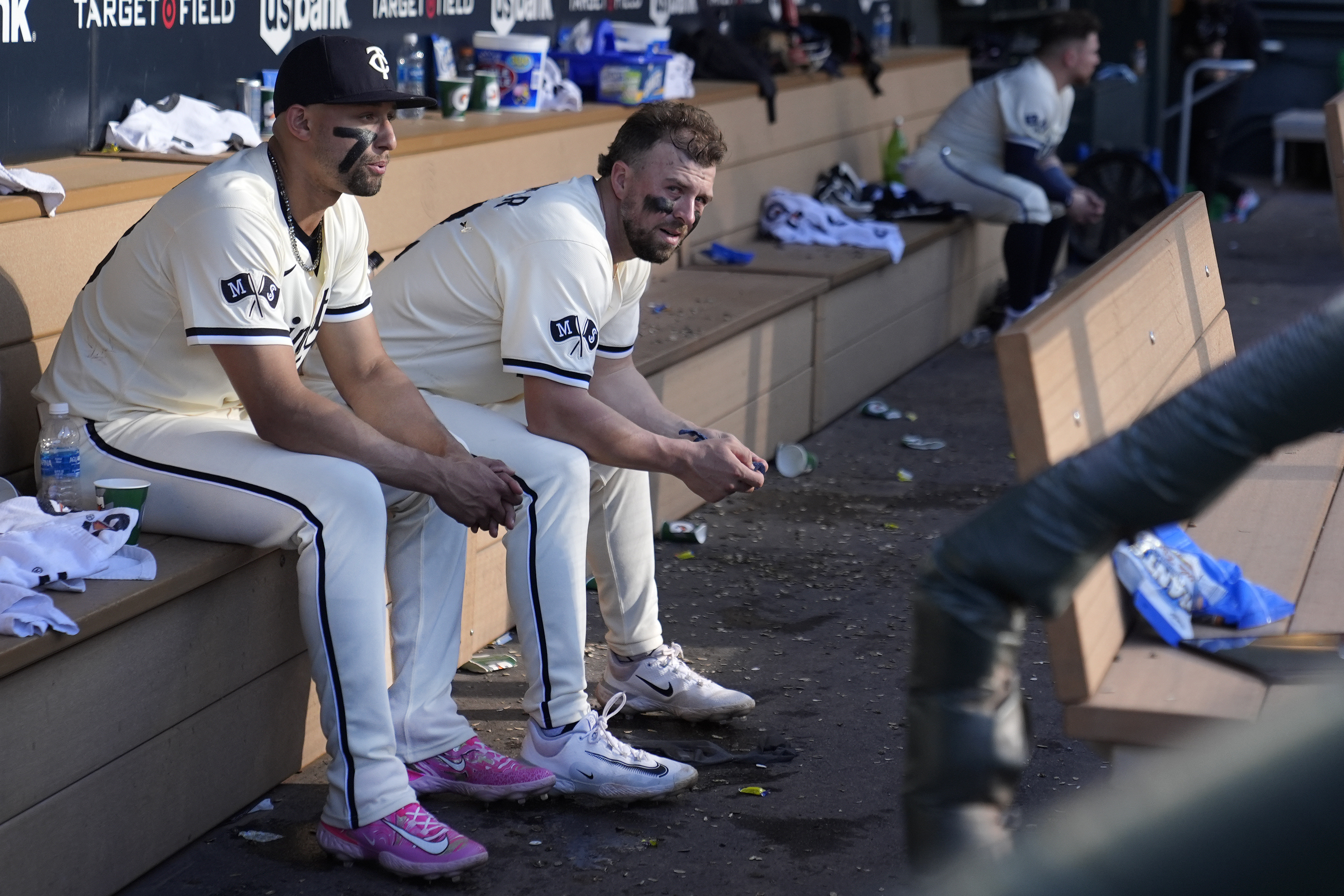 Minnesota Twins' Royce Lewis, left, and Kyle Farmer sit in the dugout after their loss to the Baltimore Orioles of a baseball game Sunday, Sept. 29, 2024, in Minneapolis. 