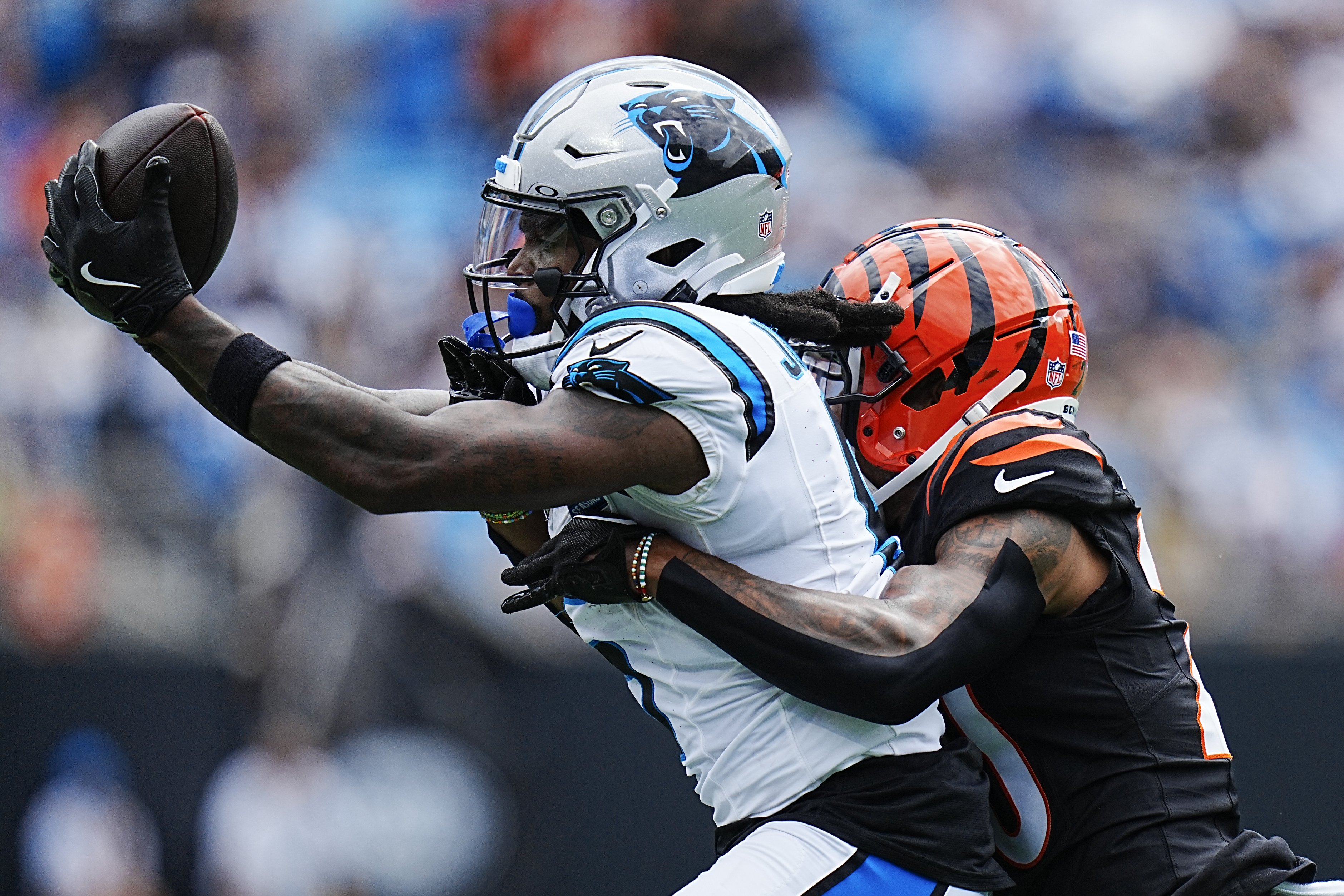 Carolina Panthers wide receiver Diontae Johnson catches a pass in front of Cincinnati Bengals cornerback DJ Turner II during the first half of an NFL football game, Sunday, Sept. 29, 2024, in Charlotte, N.C. 