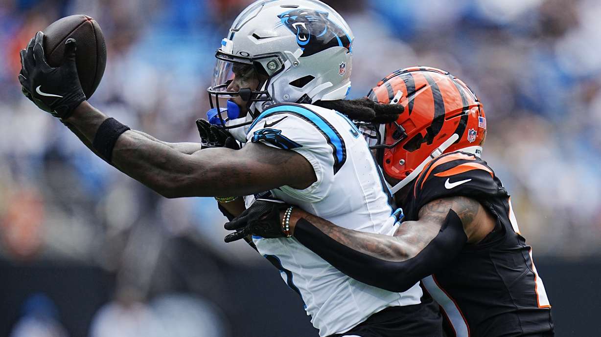 Carolina Panthers wide receiver Diontae Johnson catches a pass in front of Cincinnati Bengals cornerback DJ Turner II during the first half of an NFL football game, Sunday, Sept. 29, 2024, in Charlotte, N.C.