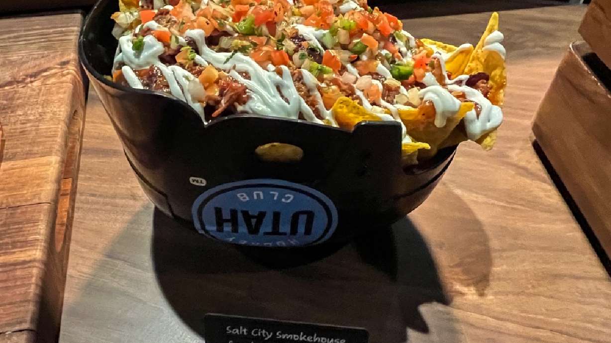 Salt City Smokehouse's "Smoked Pork Nachos" are displayed during a preview of new Delta Center offerings on Tuesday. The nachos can be served in a novelty hockey helmet, reflecting a new team that now calls the arena home