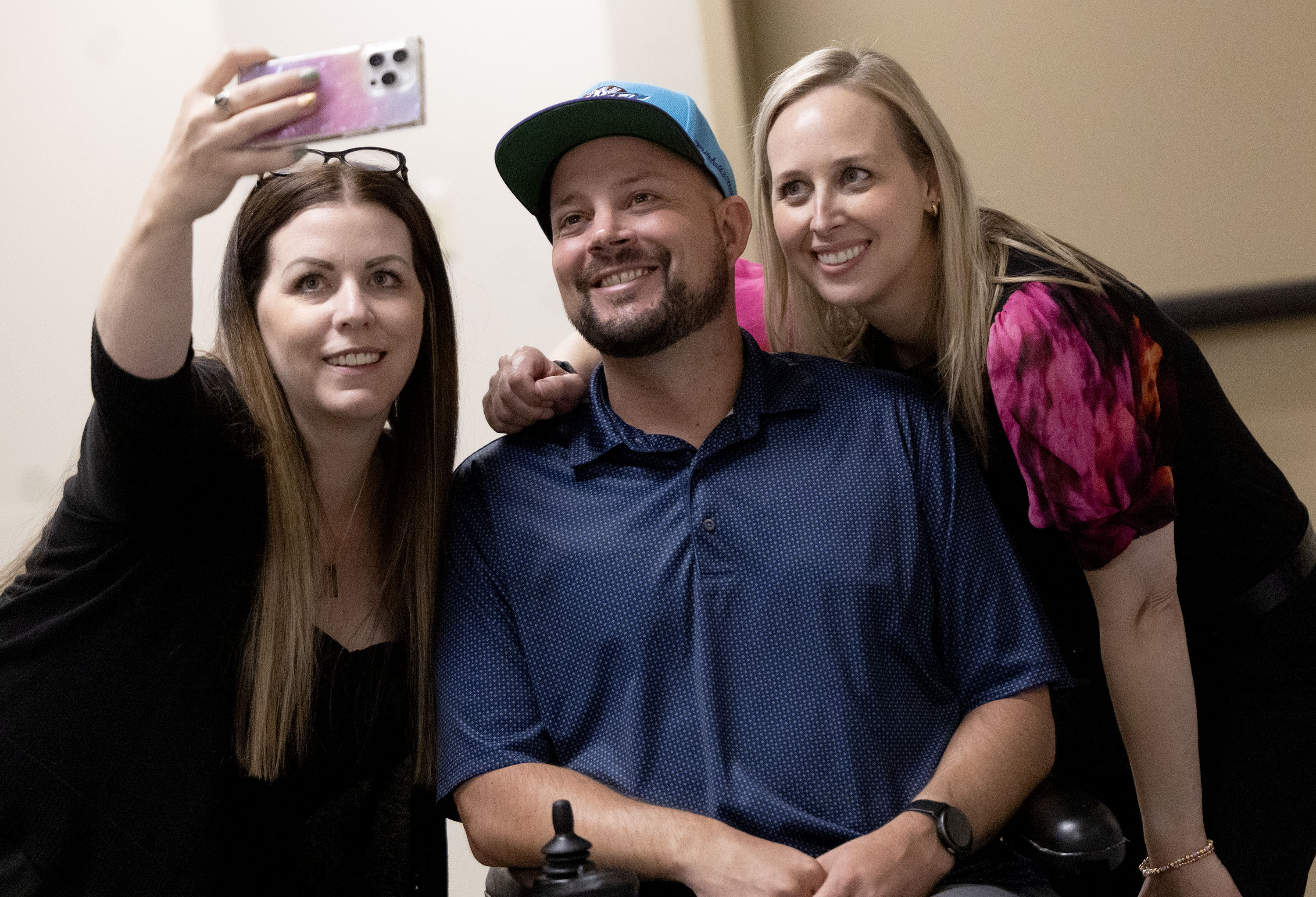 Lisa O’Brien, Blake Bockholt and Christine Maughan take a photo after speaking with members of the media about the challenges of living with long COVID at the Cannon Health Building in Salt Lake City on Wednesday.