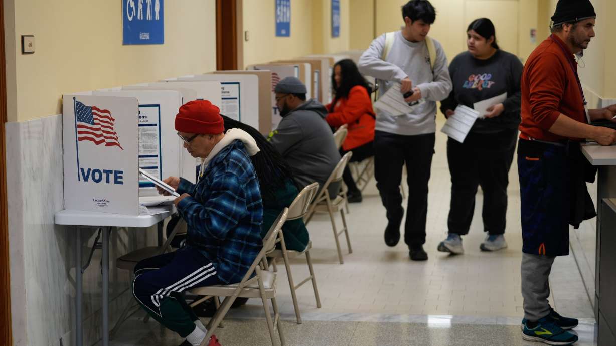 People vote and turn in their ballots at City Hall in San Francisco, March 5. Billionaire Elon Musk criticized California Gov. Gavin Newsom for signing a bill last week that would outlaw local counties in the state from requiring identification to vote.
