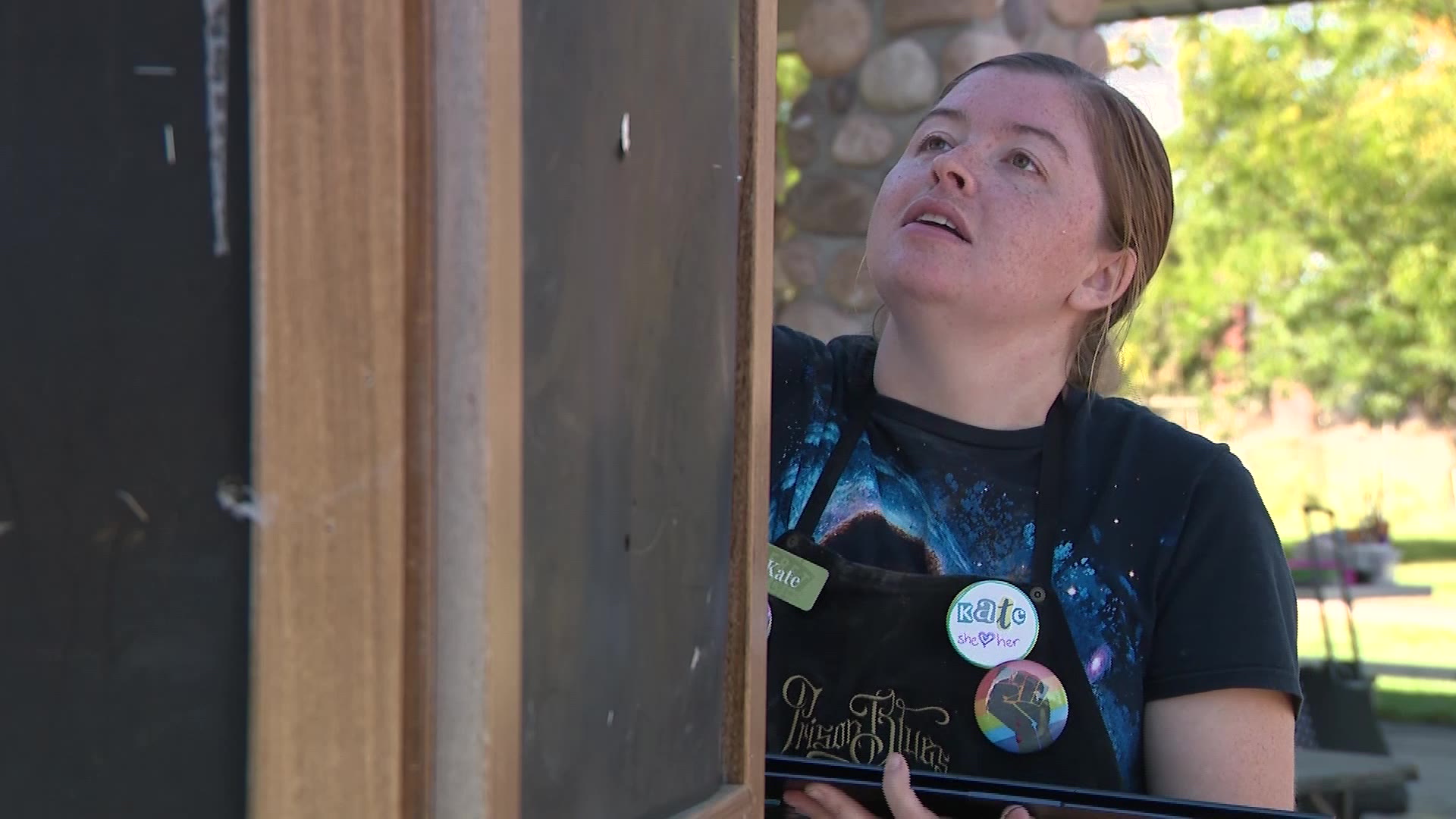 Jarmin-Gates decorating some artwork in a west Salt Lake City park on Wednesday.