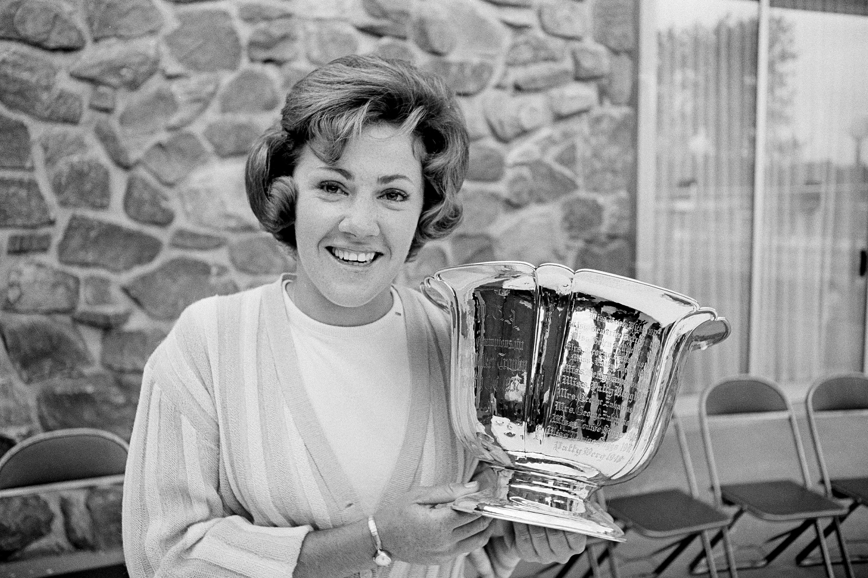FILE - Susie Maxwell holds the silver trophy after winning the 36th annual Women's Western golf tournament, June 14, 1965, in Chicago.