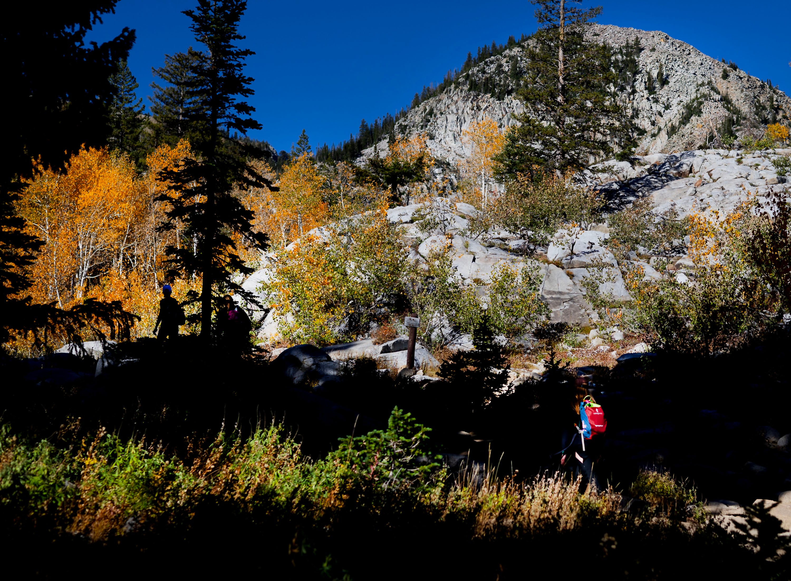 People hike the Lake Mary Trail above Brighton Resort in Big Cottonwood Canyon on Wednesday. Two candidates to be Utah's next U.S. senator think the best place to discuss economic policy, energy goals and global affairs is in a pair of hiking boots.