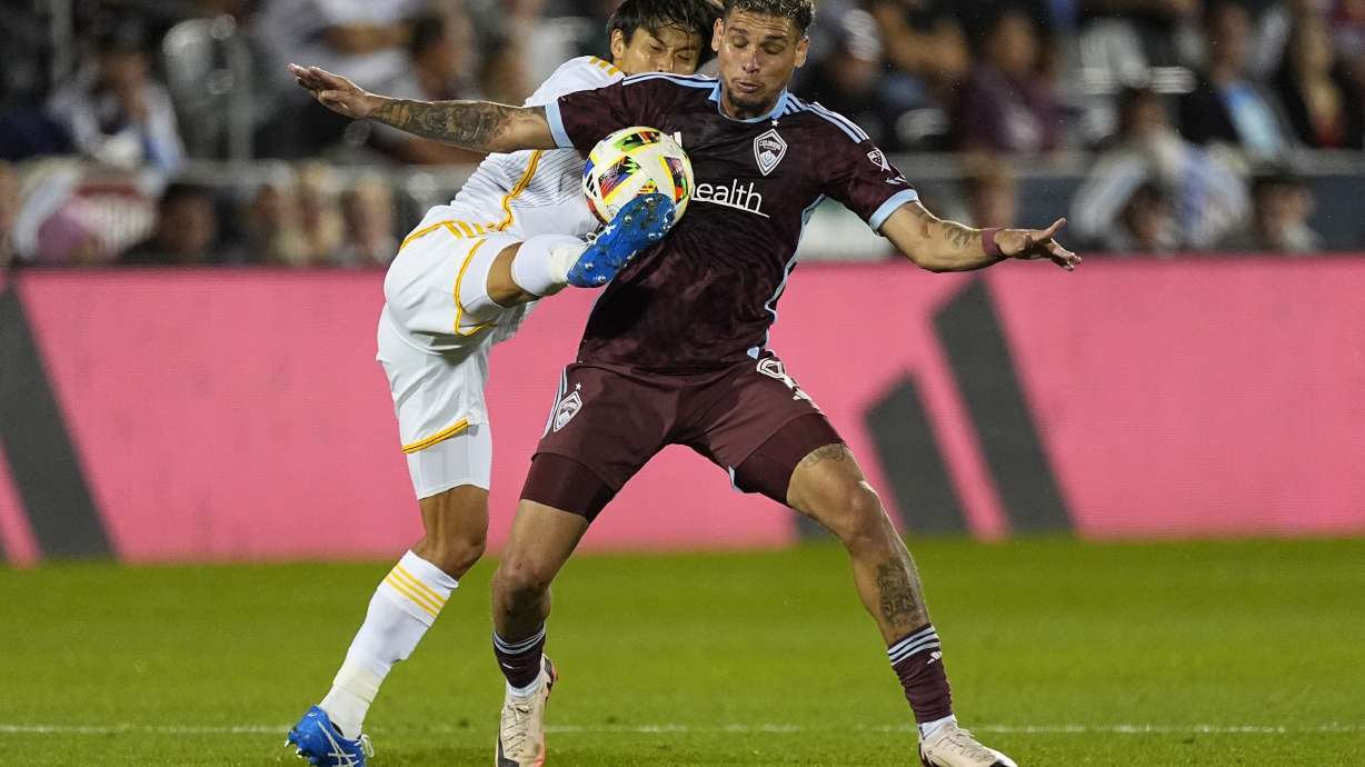 Los Angeles Galaxy defender Miki Yamane, left, kicks the ball away from Colorado Rapids forward Rafael Navarro in the second half of an MLS soccer match, Wednesday, Oct. 2, 2024, in Commerce City, Colo.