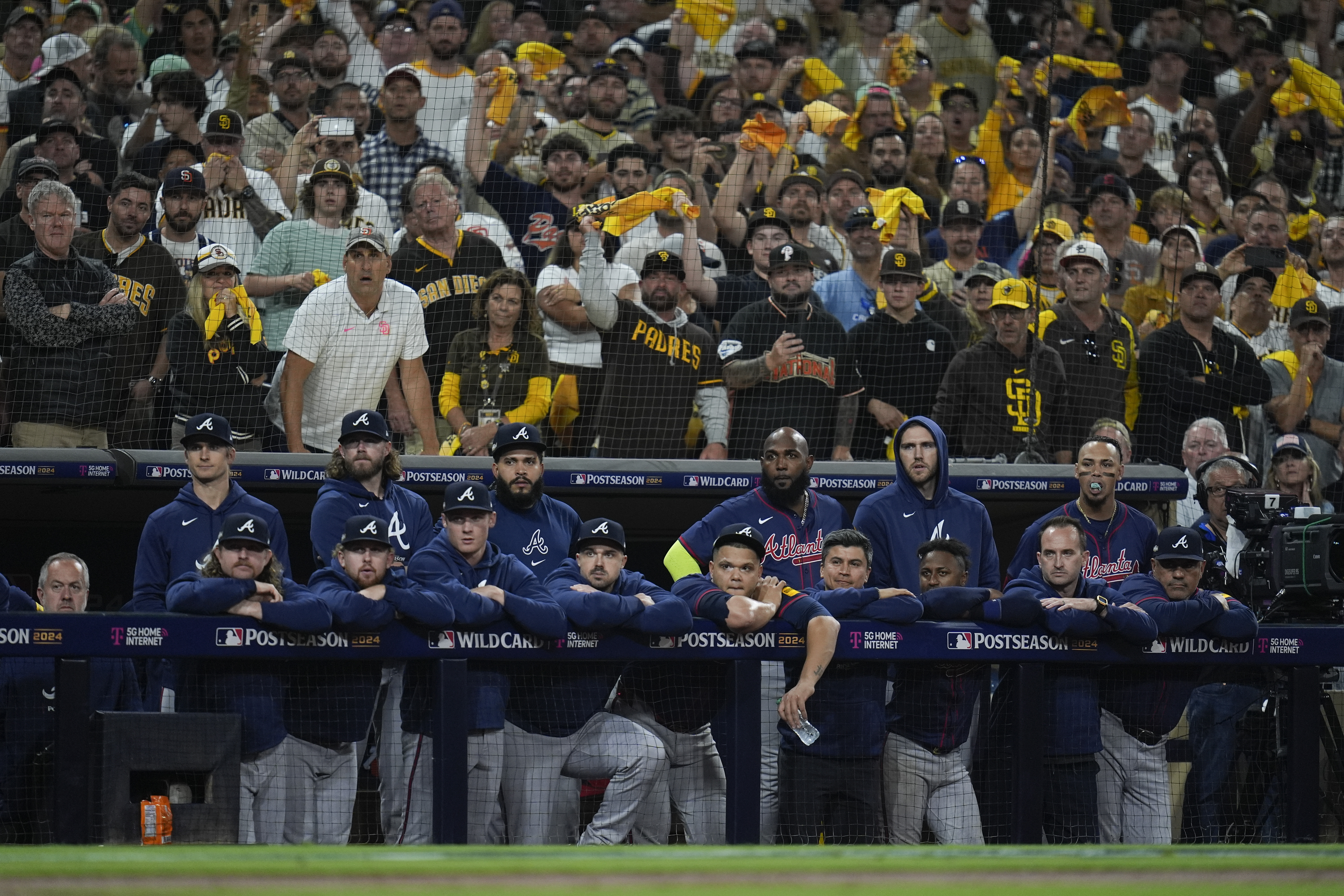 Members to the Atlanta Braves watch from the dugout during the ninth inning in Game 2 of an NL Wild Card Series baseball game against the San Diego Padres, Wednesday, Oct. 2, 2024, in San Diego.