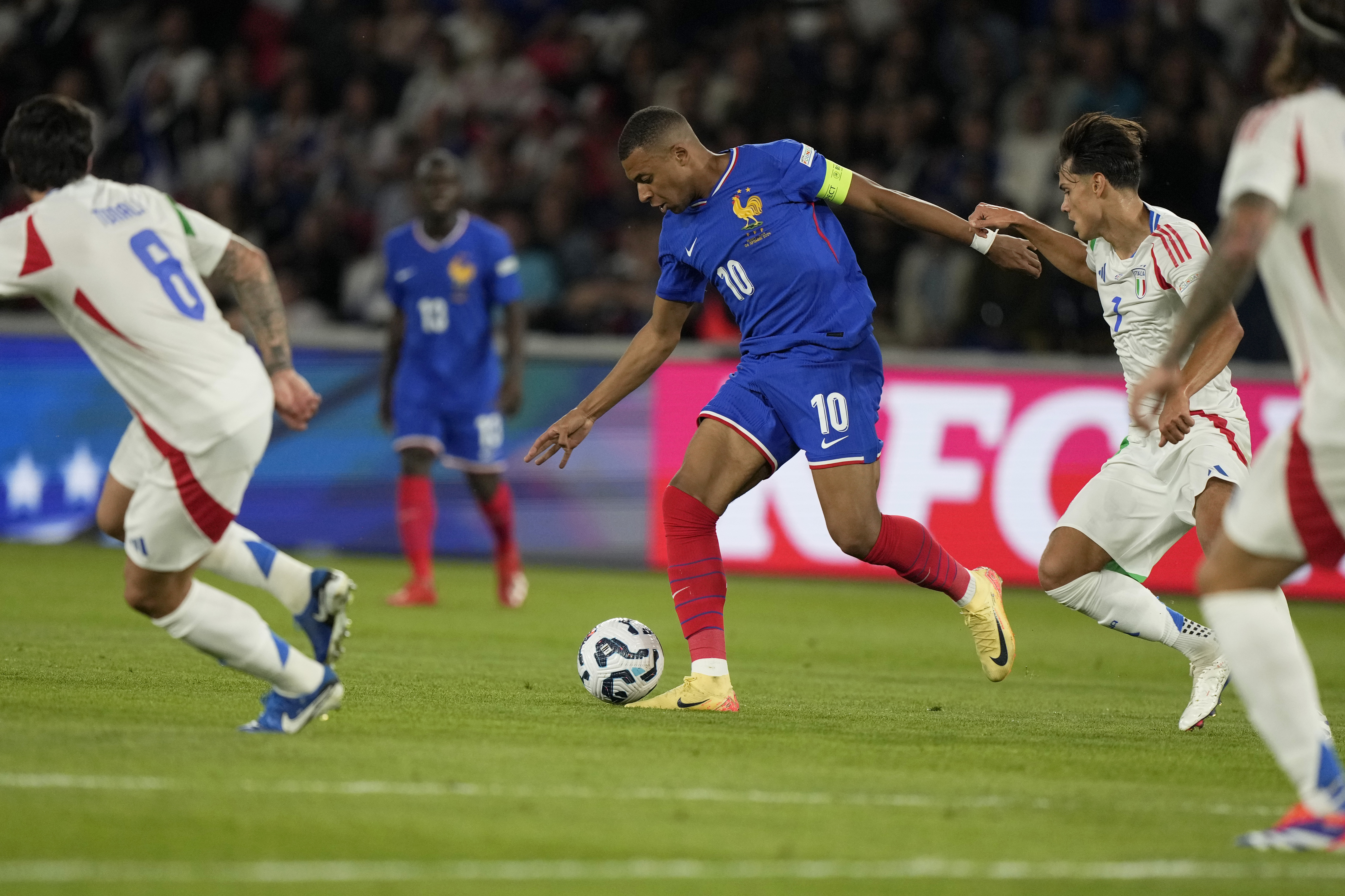 Italy's Samuele Ricci vies for the ball with France's Kylian Mbappe, center, during the UEFA Nations League soccer match between France and Italy at the Parc des Princes in Paris, Friday, Sept. 6, 2024.