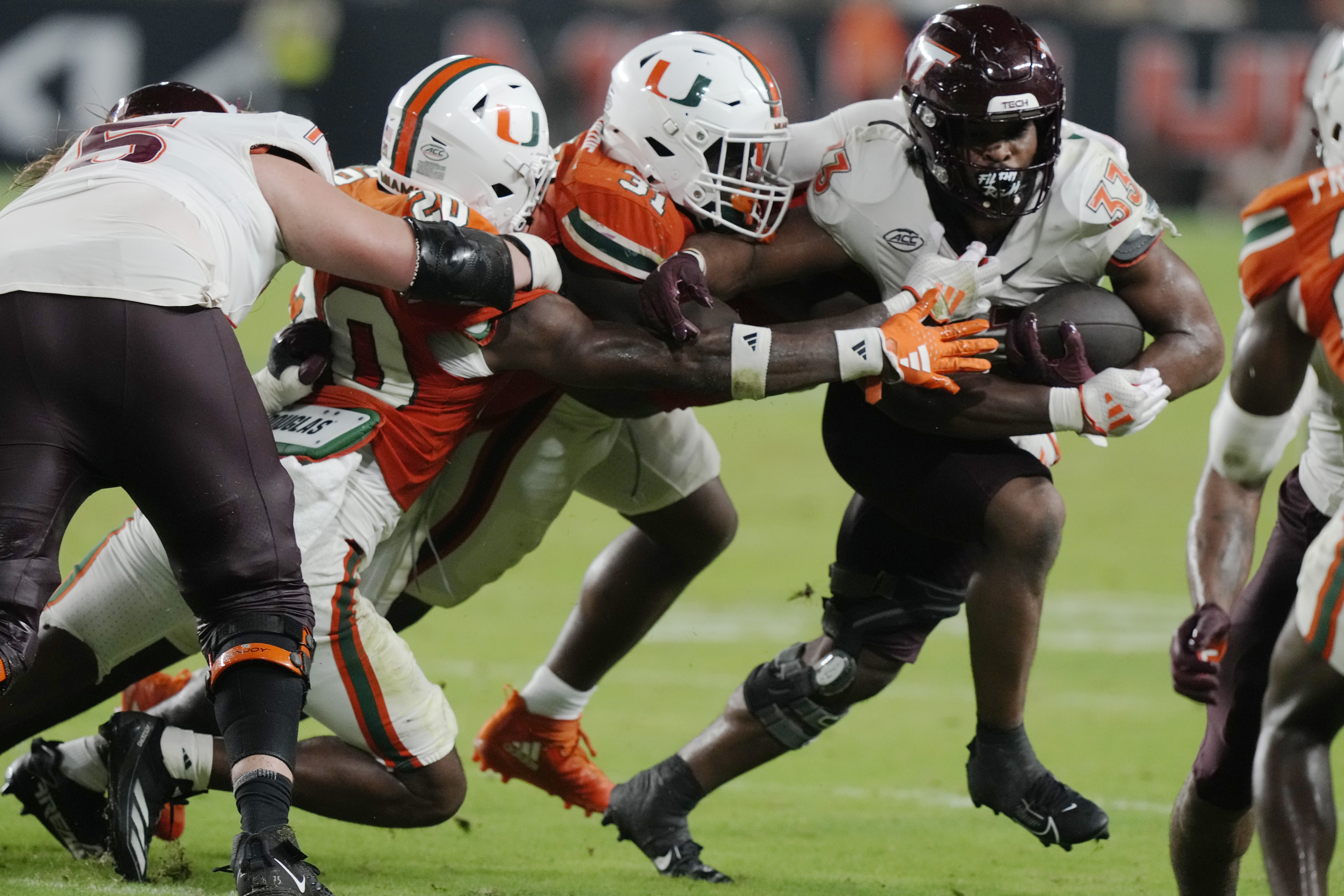 Miami linebacker Wesley Bissainthe (31) attempts to stop Virginia Tech running back Bhayshul Tuten (33) during the second half of an NCAA college football game, Friday, Sept. 27, 2024, in Miami Gardens, Fla. 