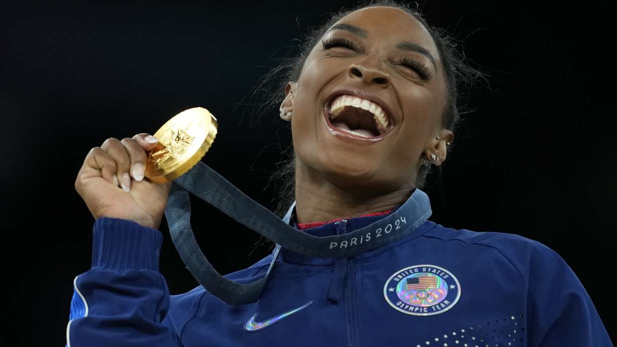 FILE - Simone Biles, of the United States, celebrates winning the gold medal during the medal ceremony in the women's artistic gymnastics individual vault finals at Bercy Arena at the 2024 Summer Olympics, Aug. 3, 2024, in Paris, France.