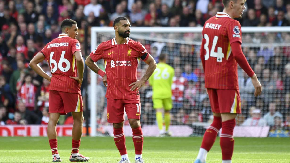 Liverpool's Trent Alexander-Arnold, left, Mohamed Salah, center, and Conor Bradley react after Nottingham Forest's Callum Hudson-Odoi scoring during the English Premier League soccer match between Liverpool and Nottingham Forest at Anfield Stadium in Liverpool, England, Saturday, Sept. 14, 2024.