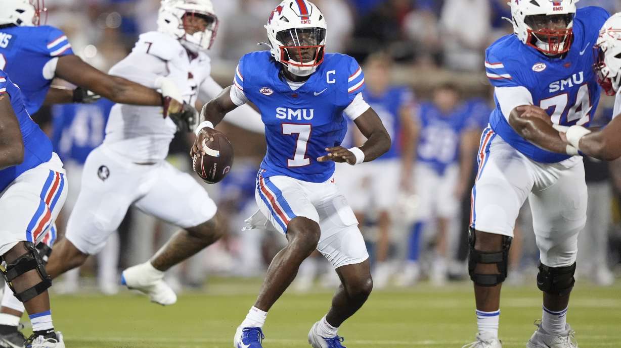 SMU quarterback Kevin Jennings (7) looks to pass the ball as lineman Andrew Chamblee (74) blocks during the first half of an NCAA college football game against Florida State, Saturday, Sept. 28, 2024, in Dallas.