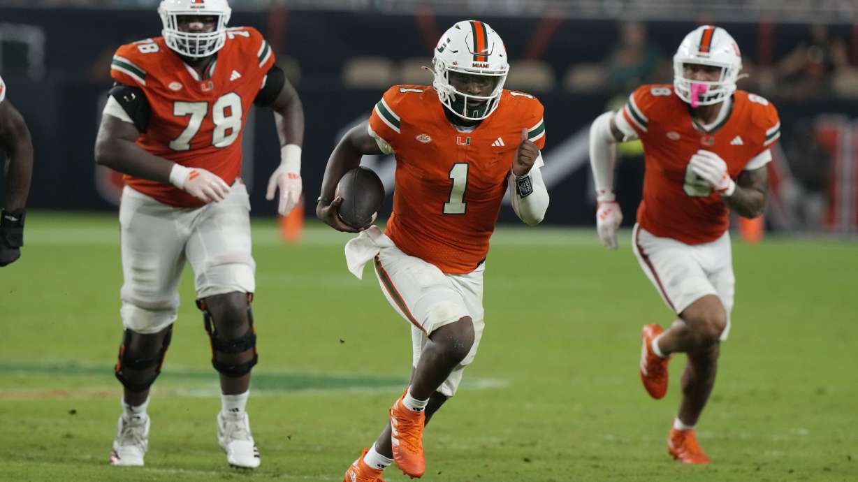 Miami quarterback Cam Ward (1) runs with the ball during the second half of an NCAA college football game against Virginia Tech , Friday, Sept. 27, 2024, in Miami Gardens, Fla.