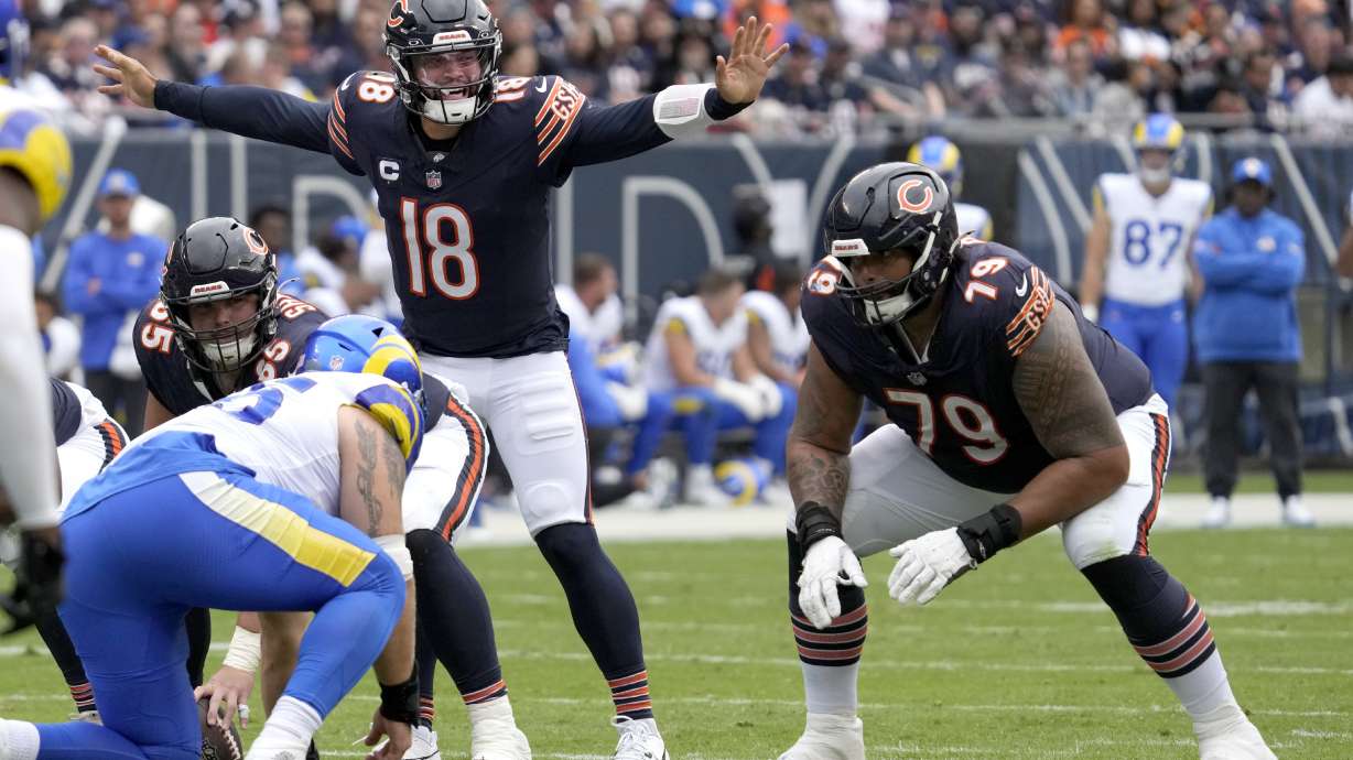 Chicago Bears quarterback Caleb Williams (18) calls a play at the line of scrimmage during the first half of an NFL football game against the Los Angeles Rams on Sunday, Sept. 29, 2024, in Chicago.