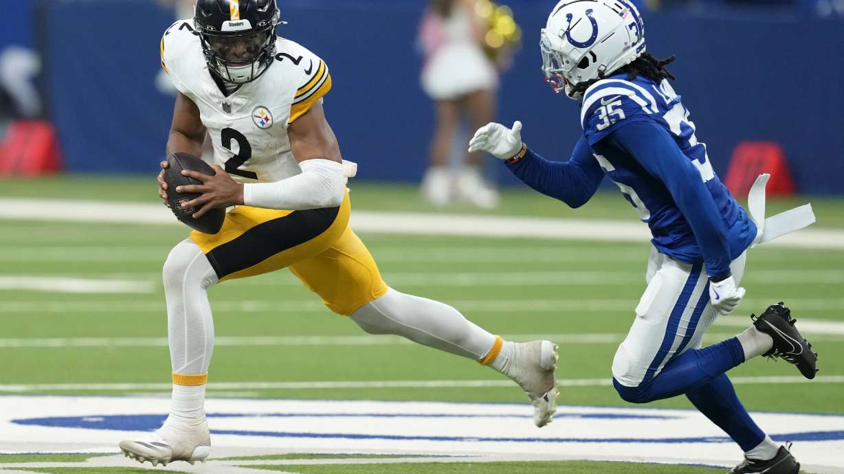 Pittsburgh Steelers quarterback Justin Fields (2) is chased out of the pocket by Indianapolis Colts cornerback Chris Lammons (35) during the second half of an NFL football game Sunday, Sept. 29, 2024, in Indianapolis.