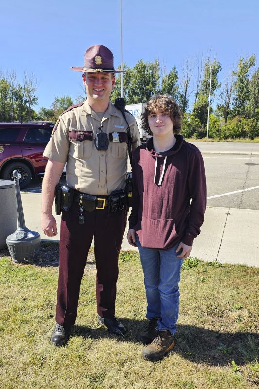 This photo shows Sam Dutcher with Minnesota State Patrol trooper Zach Gruver at the Travel Center in Moorhead, Minn., Sept. 25.