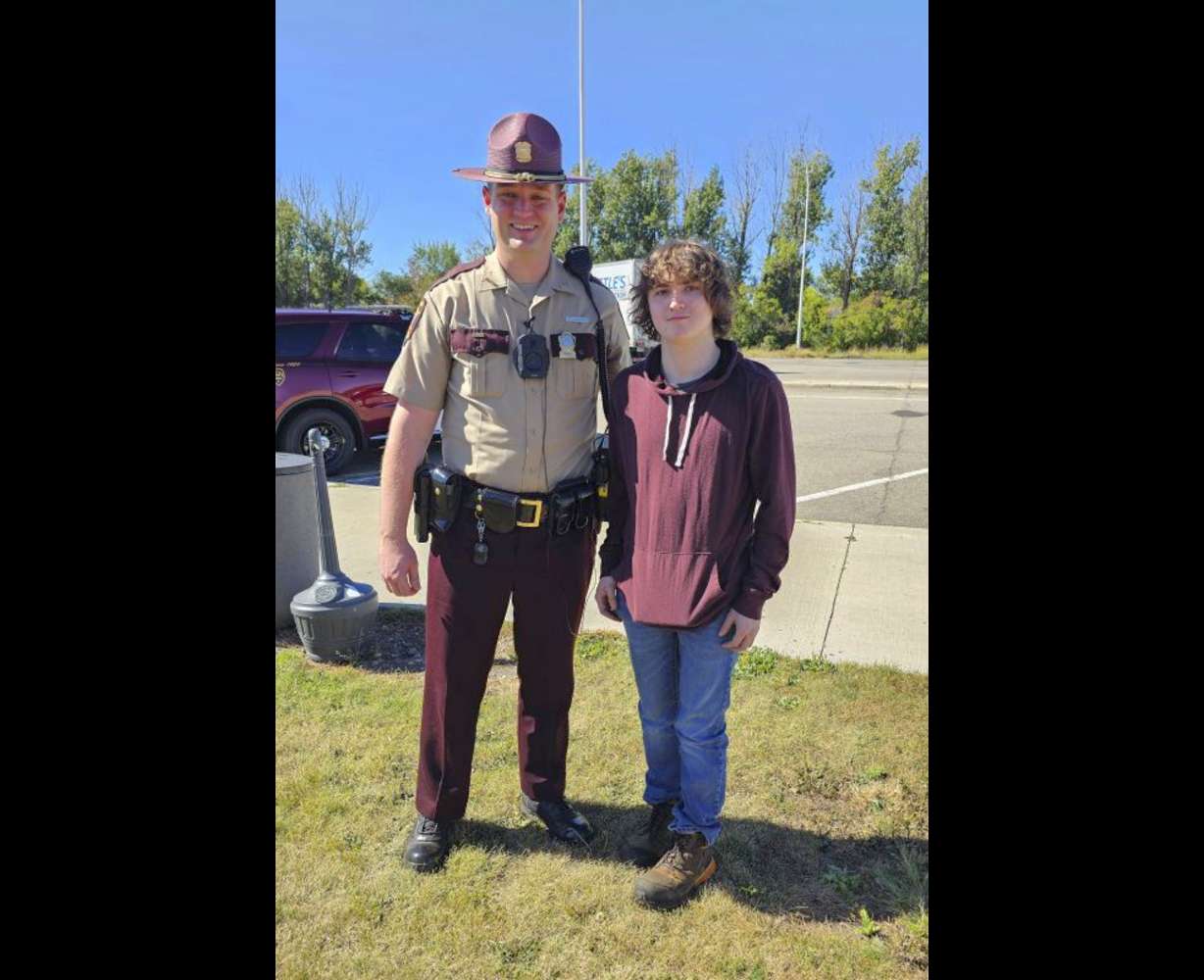 This photo shows Sam Dutcher with Minnesota State Patrol trooper Zach Gruver at the Travel Center in Moorhead, Minn., Sept. 25.