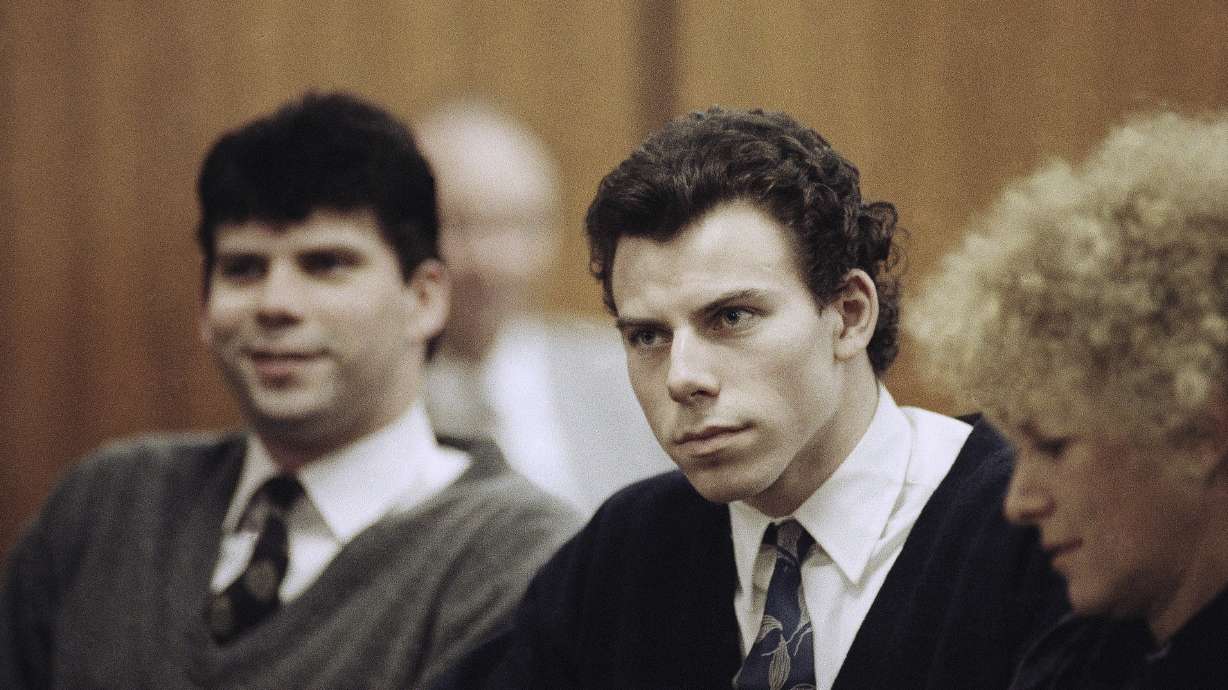 Lyle Menendez, left, and Erik Menendez sit with defense attorney Leslie Abramson, right, in Beverly Hills Municipal Court during a hearing, Nov. 26, 1990. Prosecutors will review new evidence in their 1996 murder conviction.