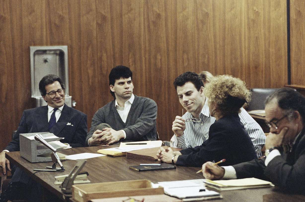 Erik Menendez, center, listens to his attorney Leslie Abramson, as his brother Lyle looks on in Beverly Hills, Calif., May 17, 1991.