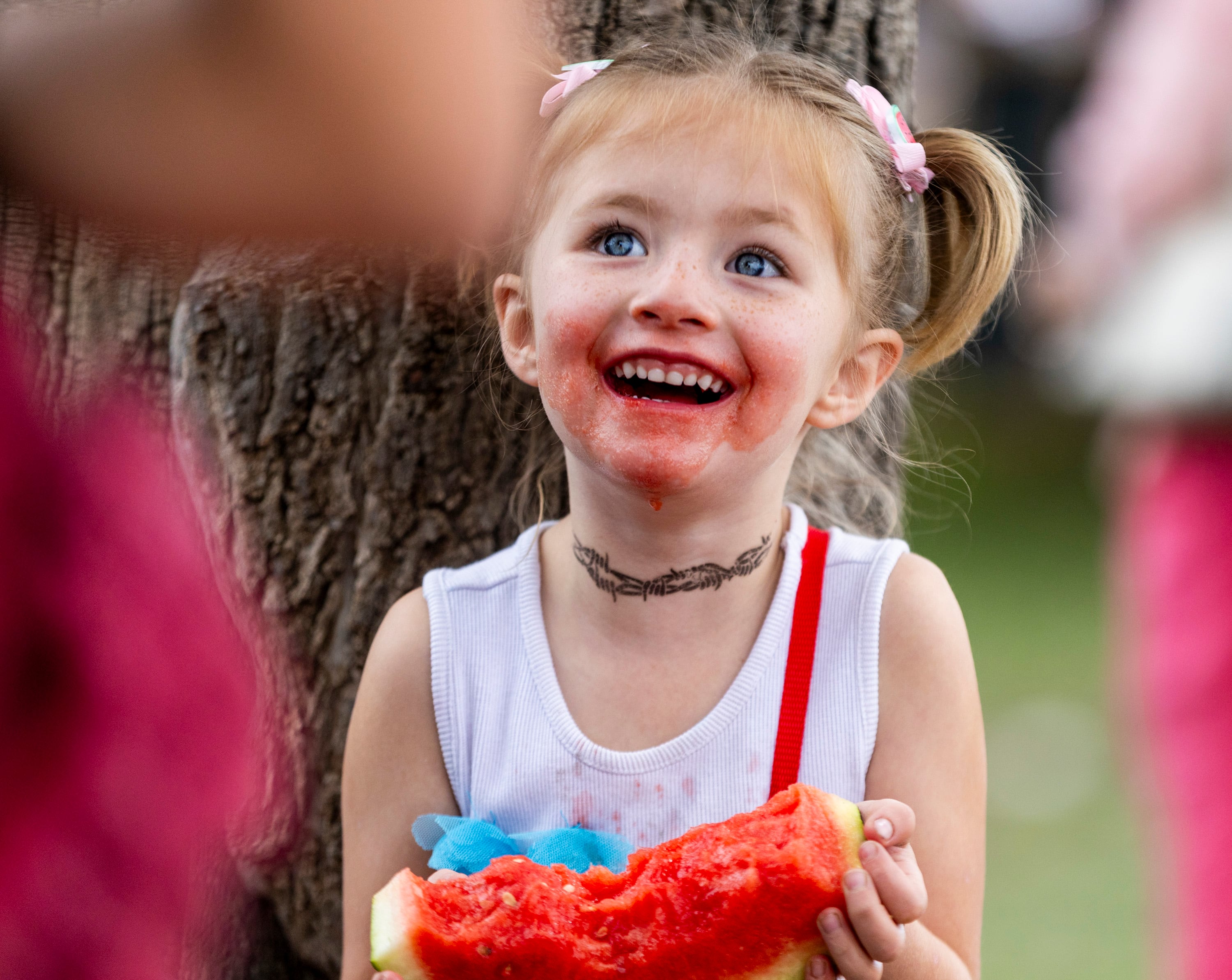 Aurora Tucker, 5, from Grand Junction, Colo., laughs with a watermelon-stained face during the 118th annual Melon Days Festival in Green River on Sept. 21.